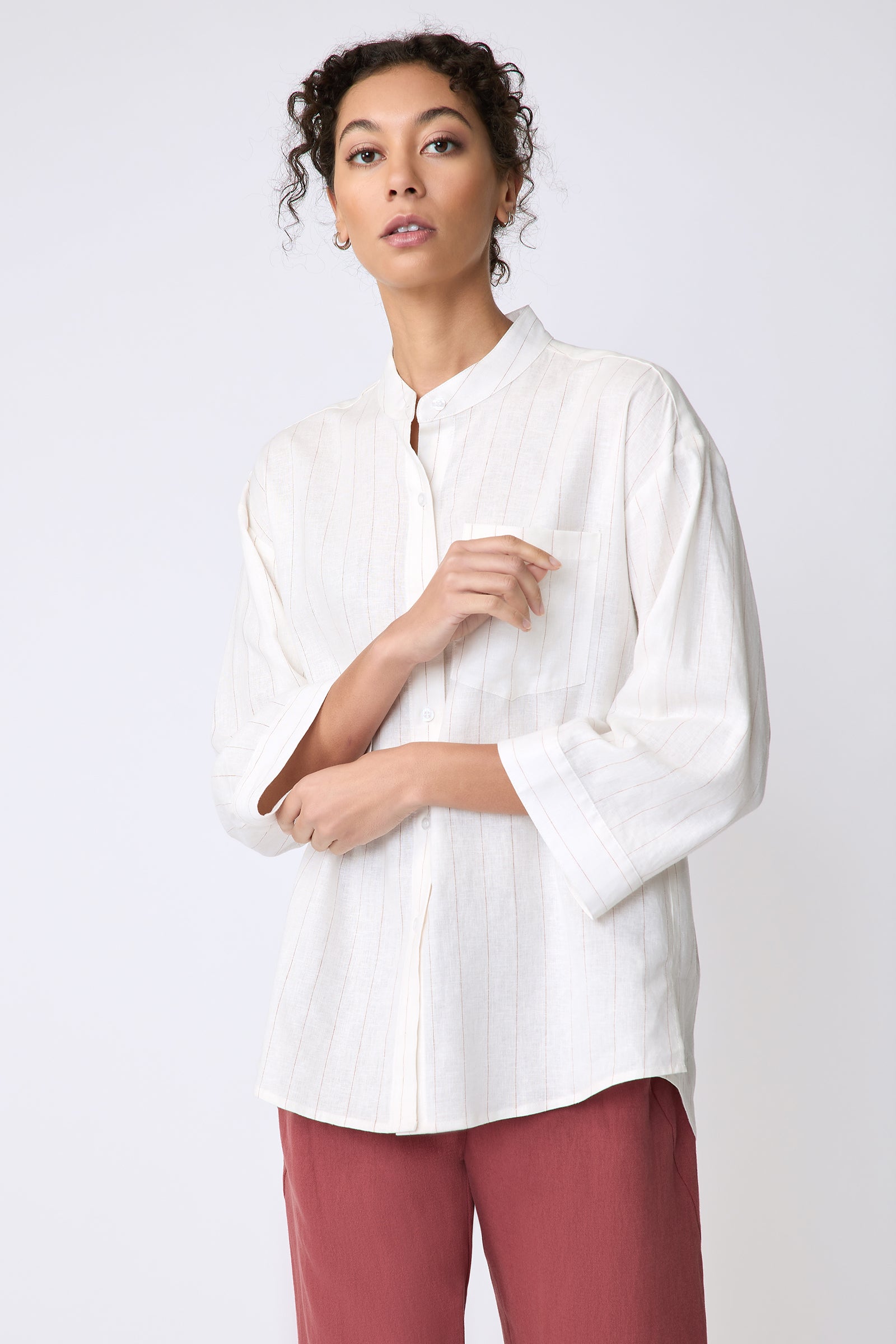 Kal Rieman Valerie Top in pinstripe linen on model front view holding cuffs