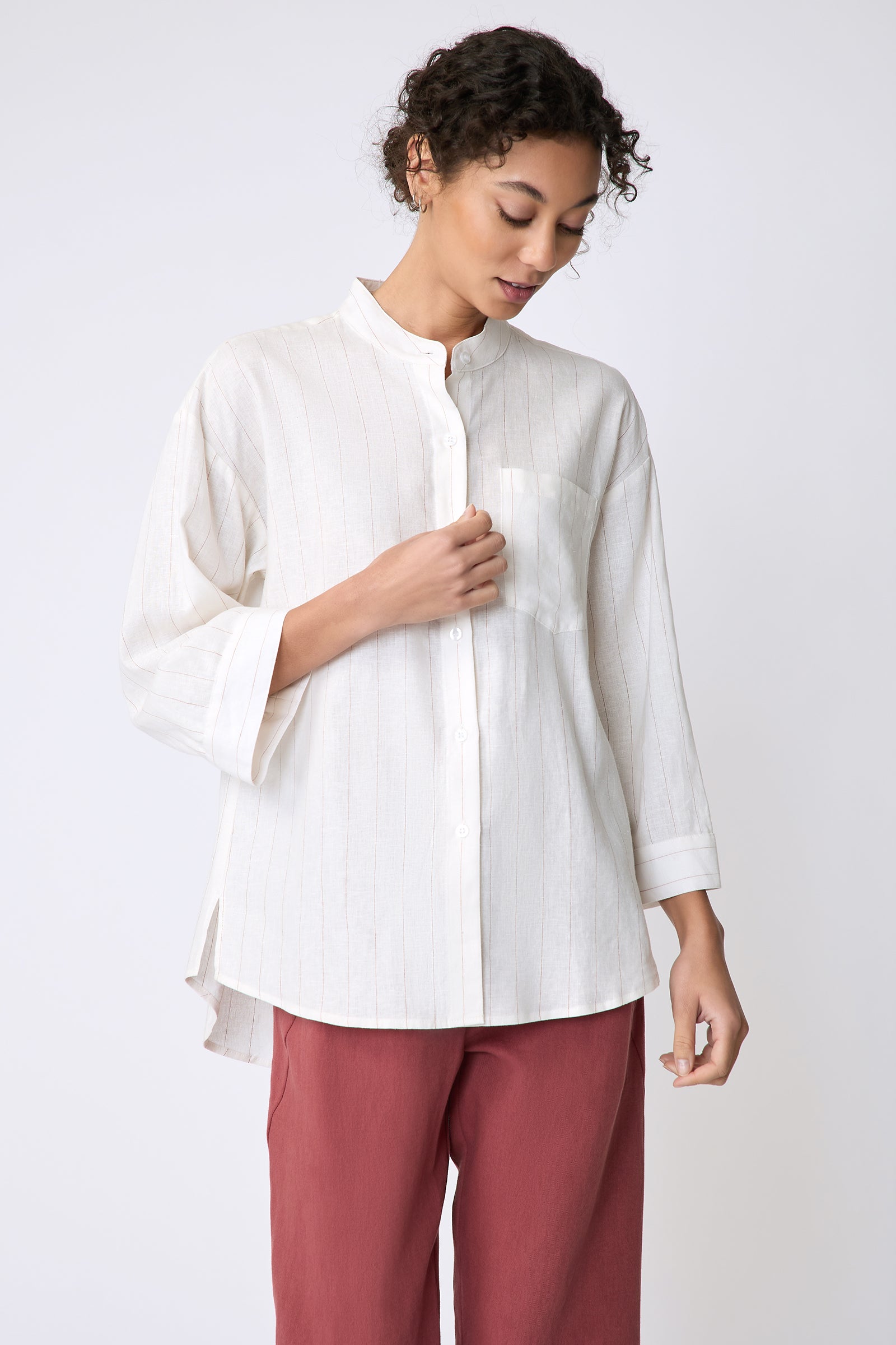 Kal Rieman Valerie Top in pinstripe linen on model front view holding placket