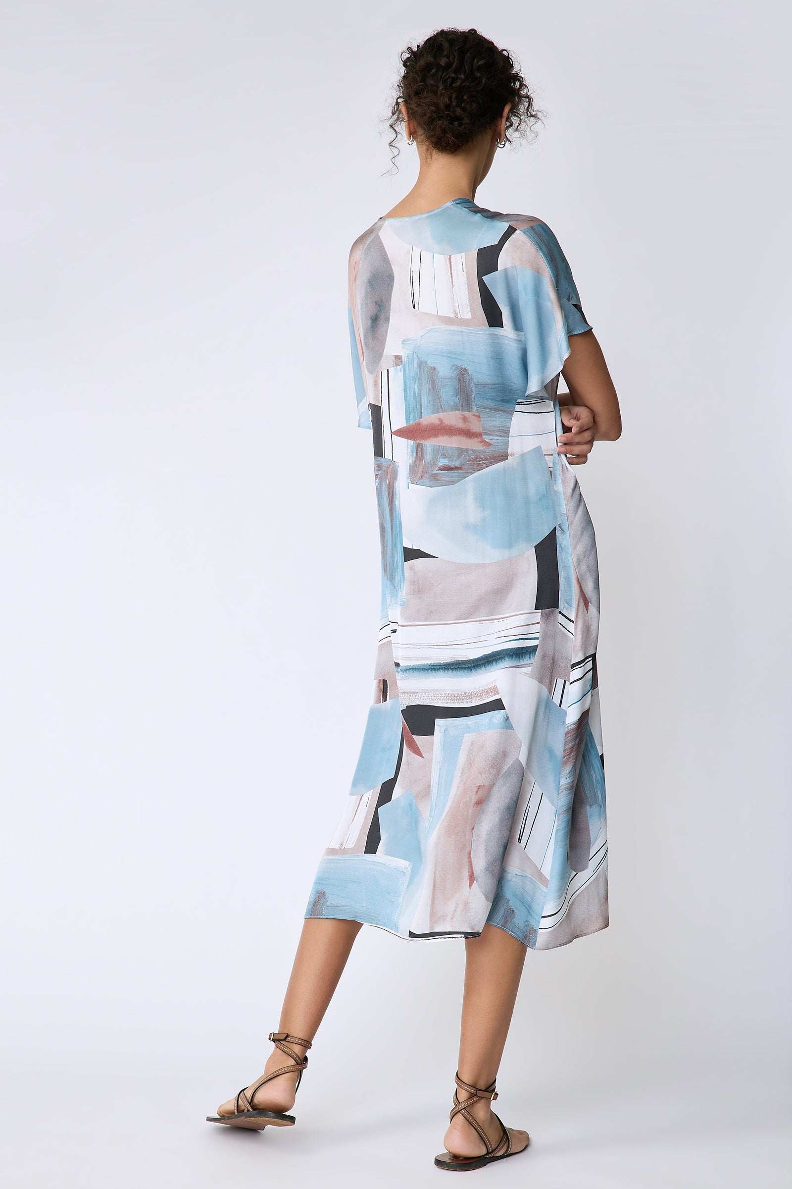 Kal Rieman Vanna Dress in Sante Fe Print blue on model back view arm crossed in front