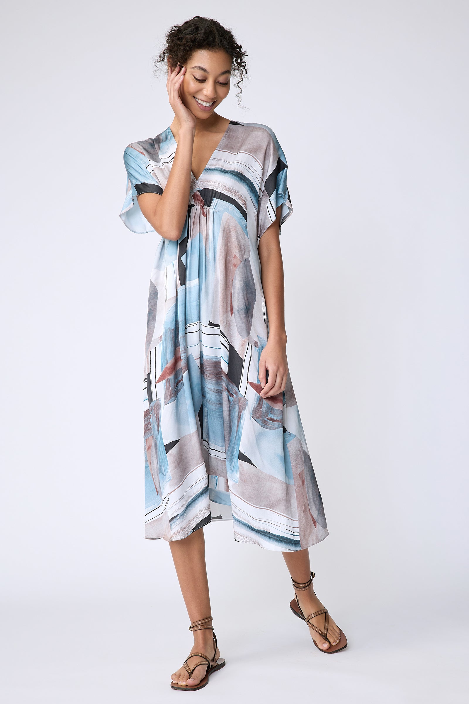 Kal Rieman Vanna Dress in Sante Fe Print blue on model front view hand on face