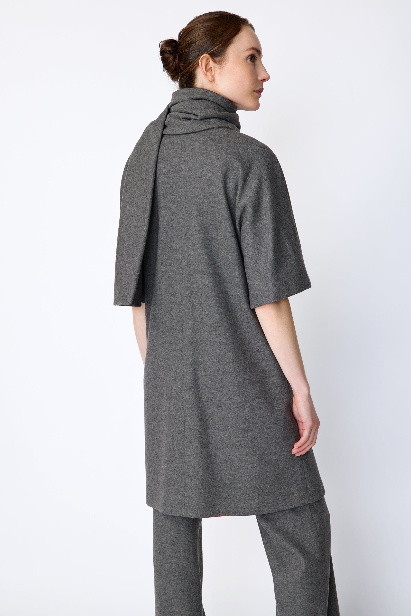 Woman wearing Kal Rieman York Cardigan  in Grey Italian Felted Jersey with Kal Rieman Felted Jersey Wide Leg pants in Grey italian Felted Jersey, arms on the side,  close back view,  looking sideways