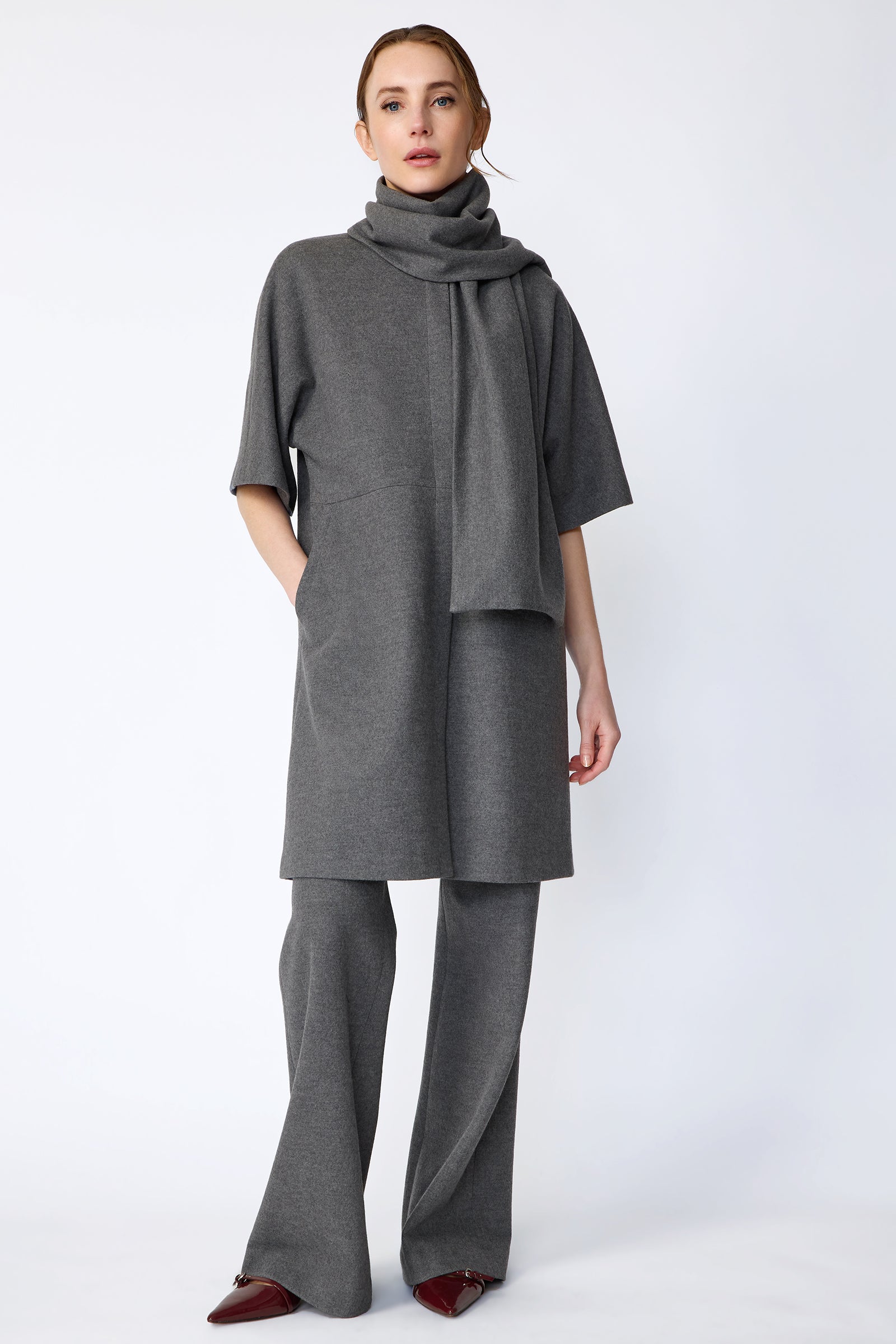Woman wearing Kal Rieman York Cardigan  in Grey Italian Felted Jersey with Kal Rieman Felted Jersey Wide Leg pants in Grey italian Felted Jersey and burgundy shoes, hands in poket, full front view