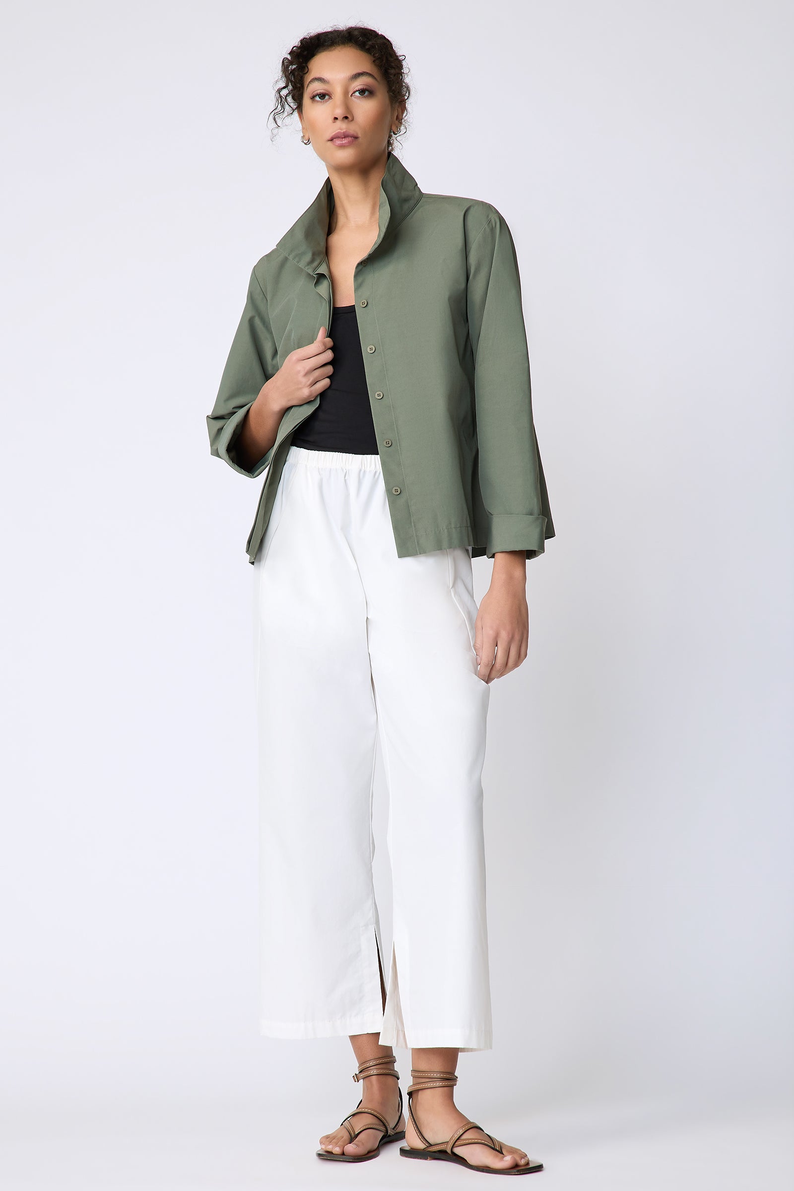 Peggy jacket in Italian Broadcloth in color cactus on model front view full look holding placket