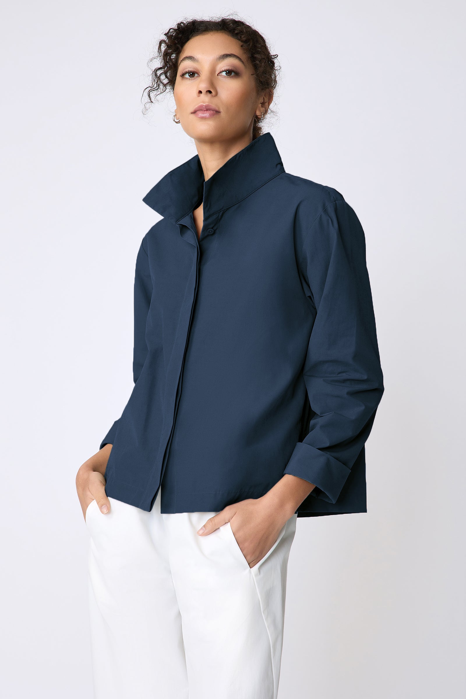 Peggy jacket in Italian Broadcloth in color summer navy on 3 4 view hands in pockets