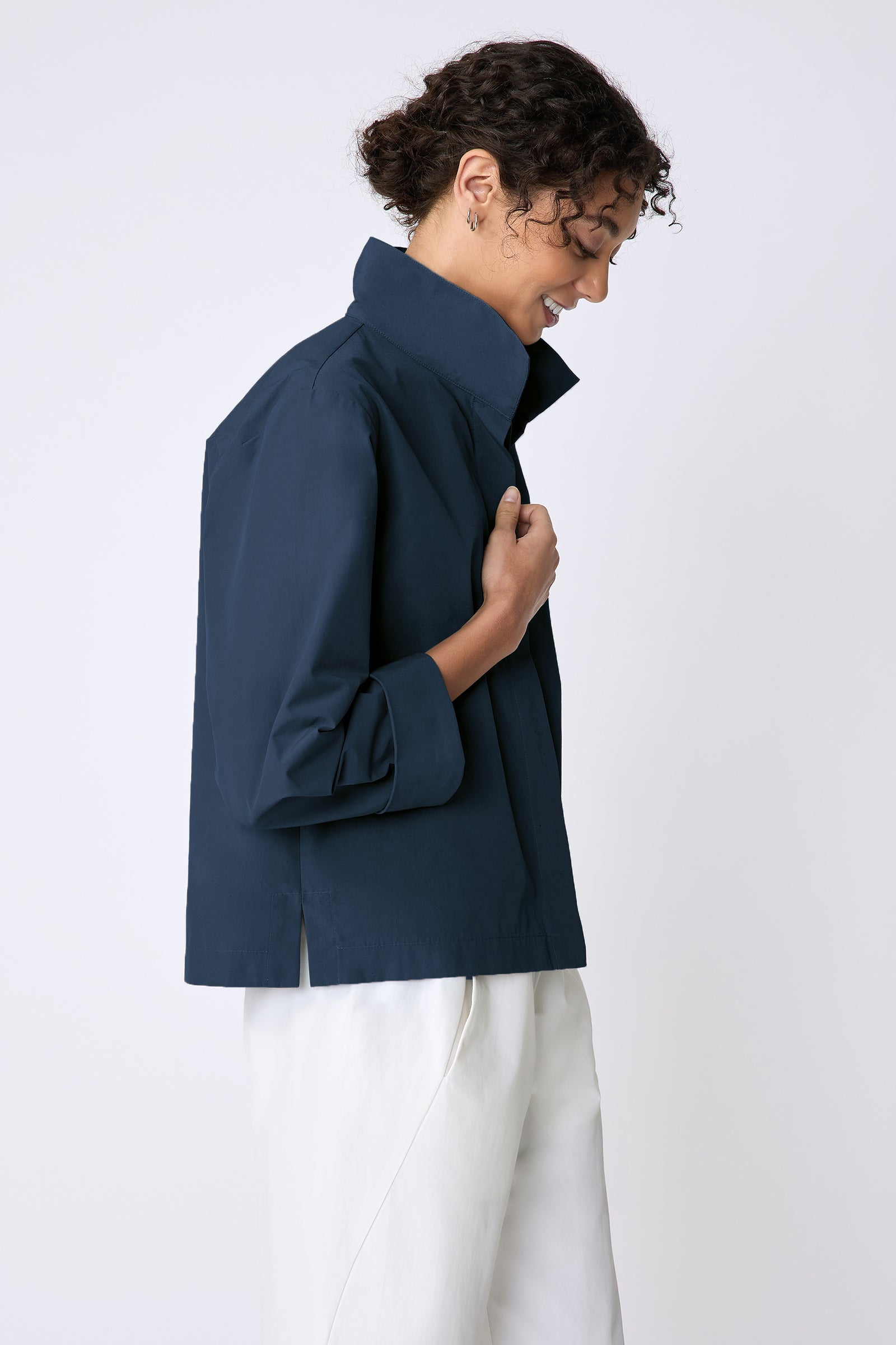 Peggy jacket in Italian Broadcloth in color summer navy on side view holding lapel