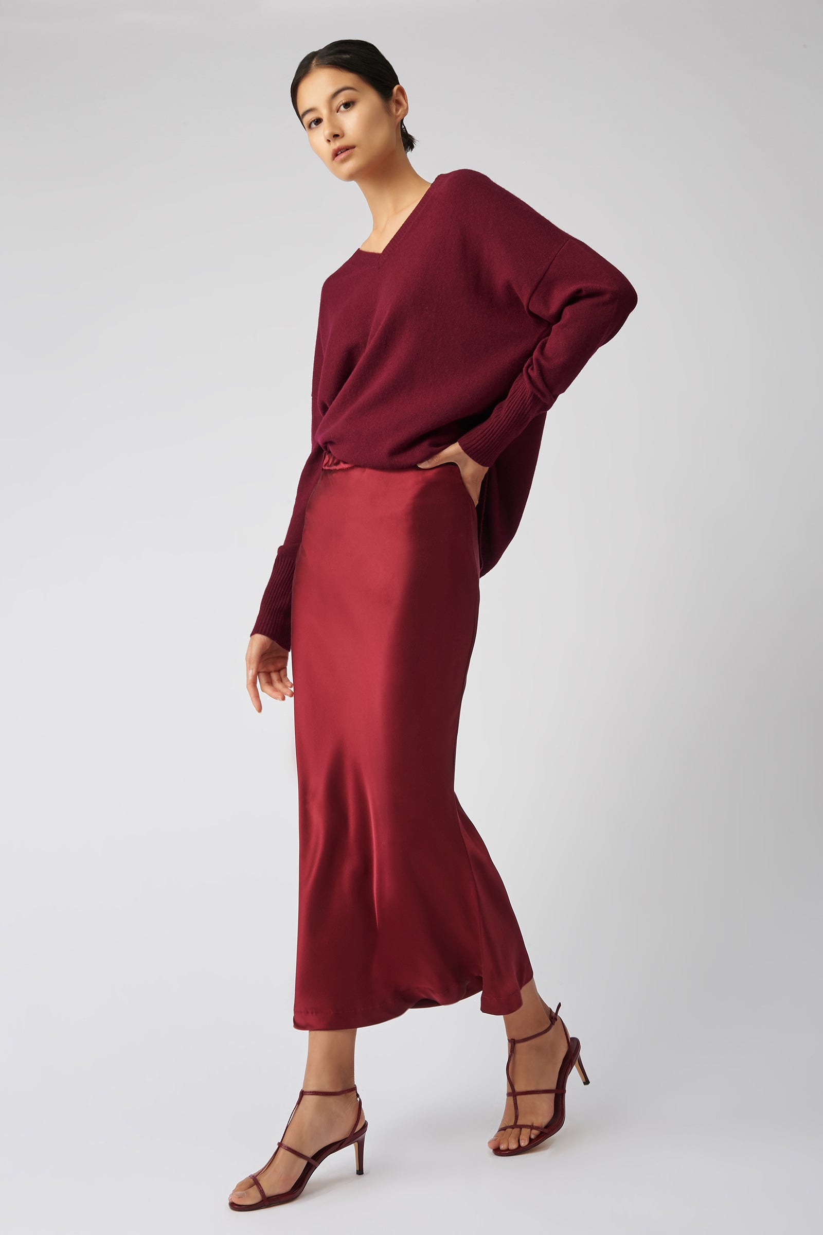 Kal Rieman Bias Silk Skirt in bordeaux on model side view holding hip