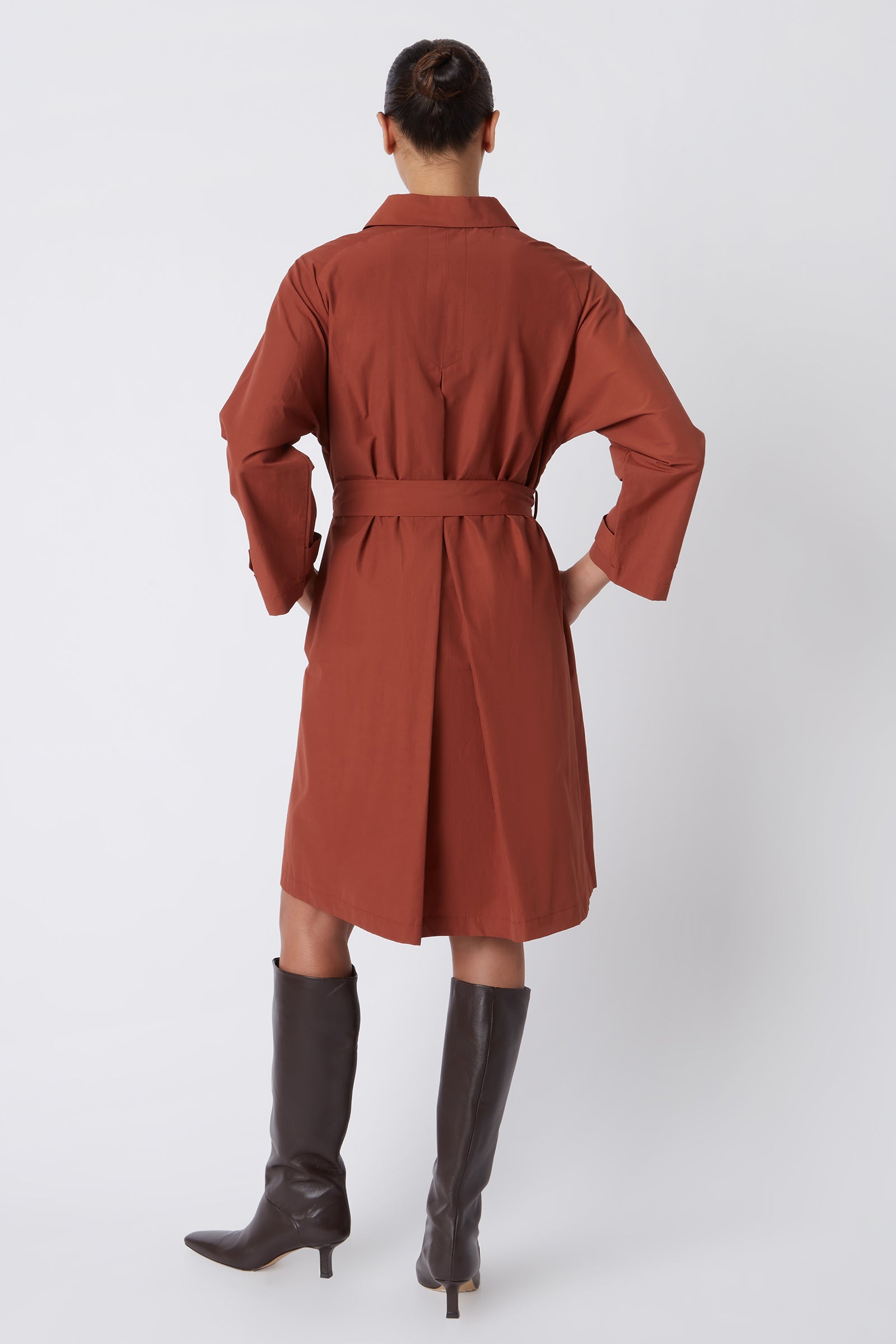 Kal Rieman Bonnie Pleat Back Dress in Rust Italian Broadcloth on Model with Hand on Dress Full Front View