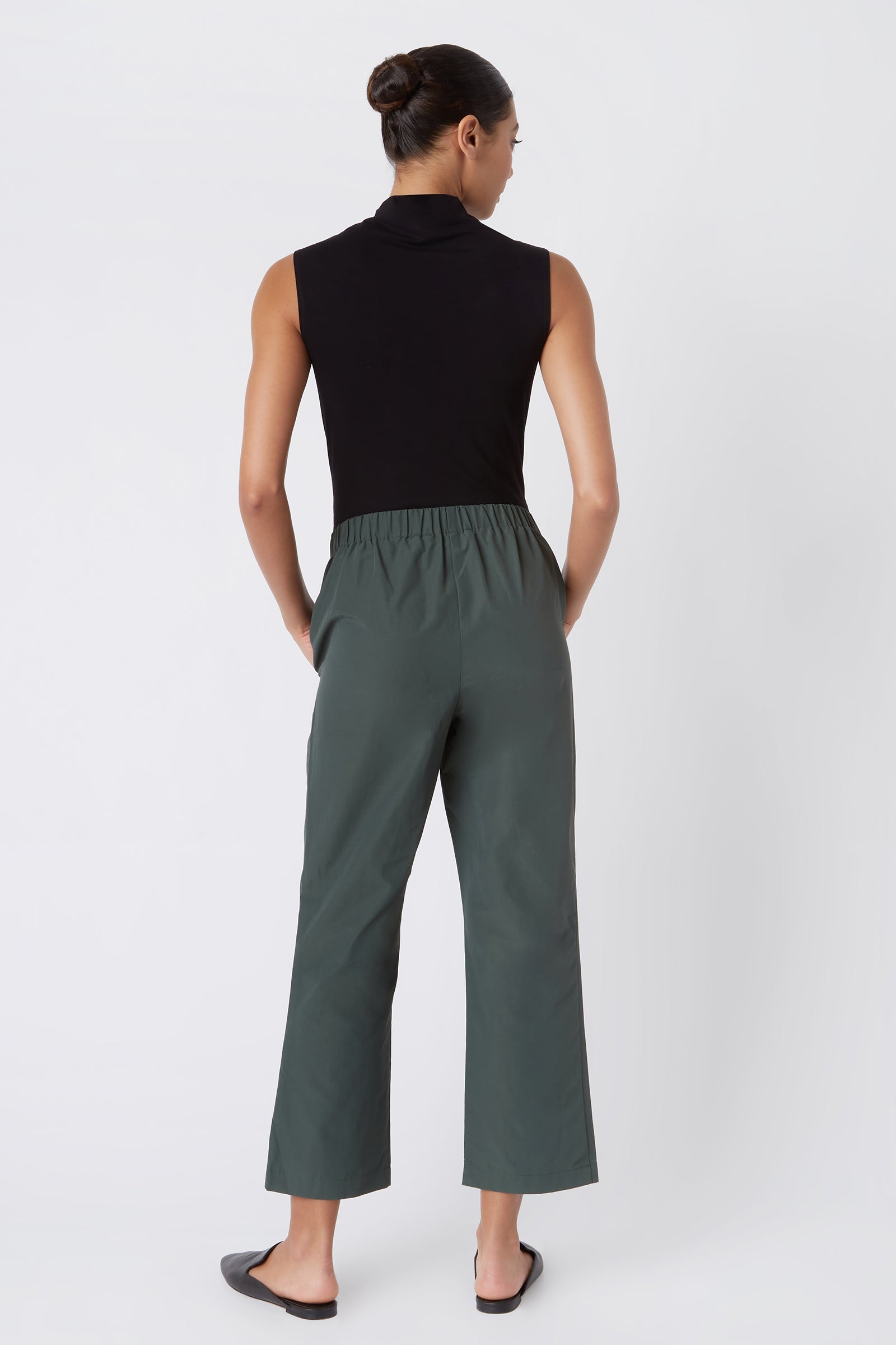 Kal Rieman Brit Crop Pant in Loden on Model with Hands in Pockets Full Front Side View