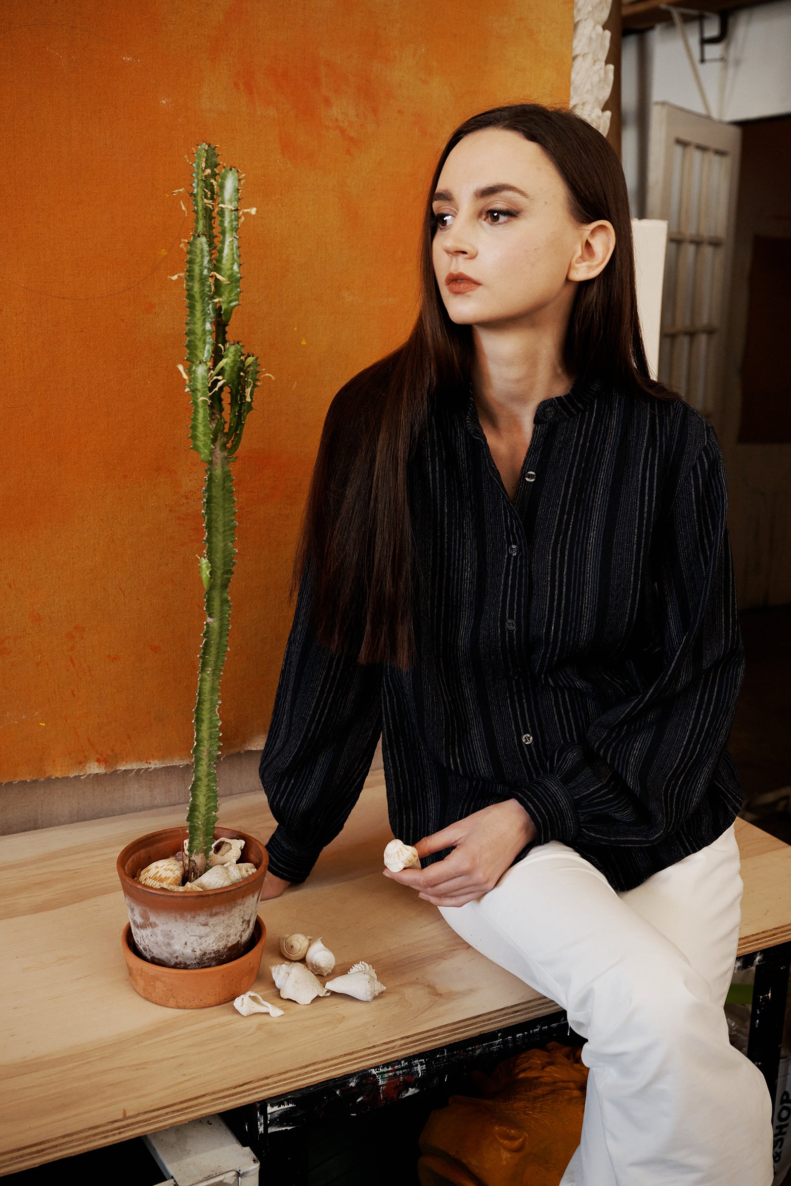Kal Rieman Jolene Poet Blouse in Navy Stripe on Model sitting on table