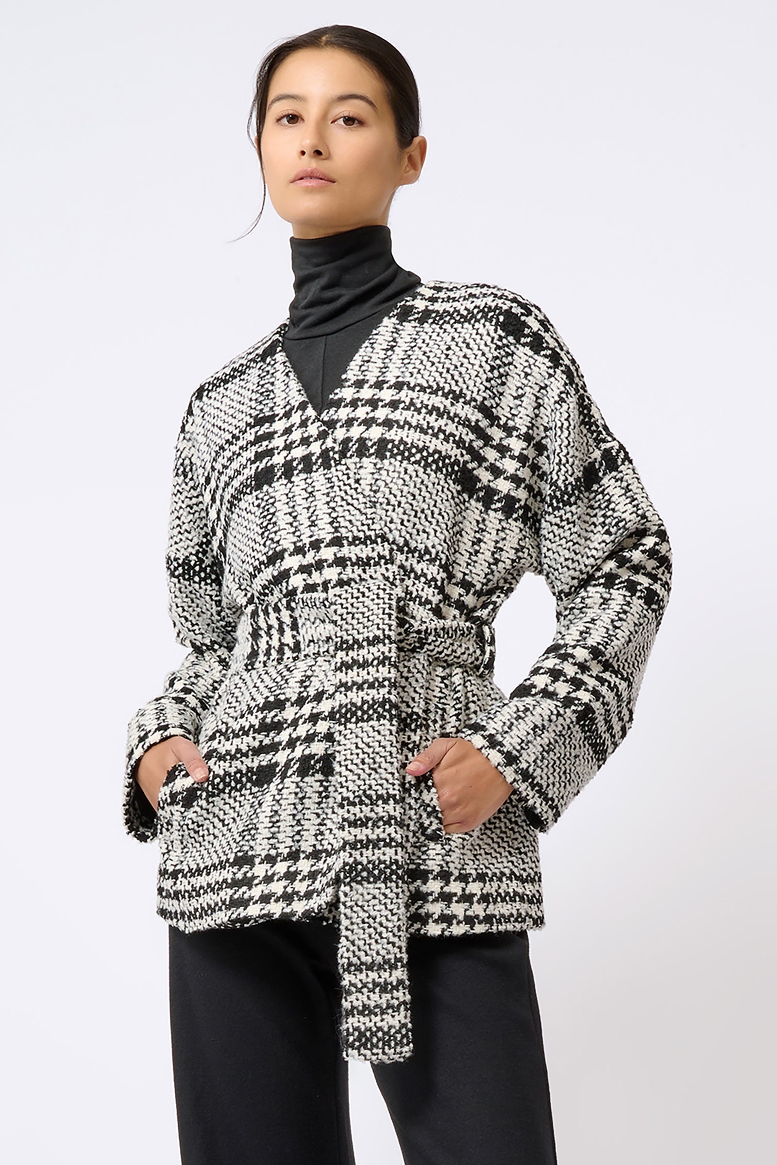 Kal Rieman Belted Cardigan in Black and White Plaid on Model with Hands in Pockets Front View