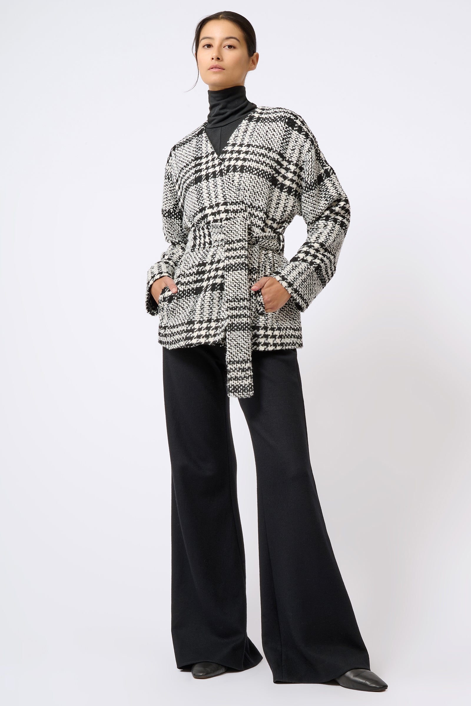 Kal Rieman Belted Cardigan in Black and White Plaid on Model with Hands in Pockets Full Front View