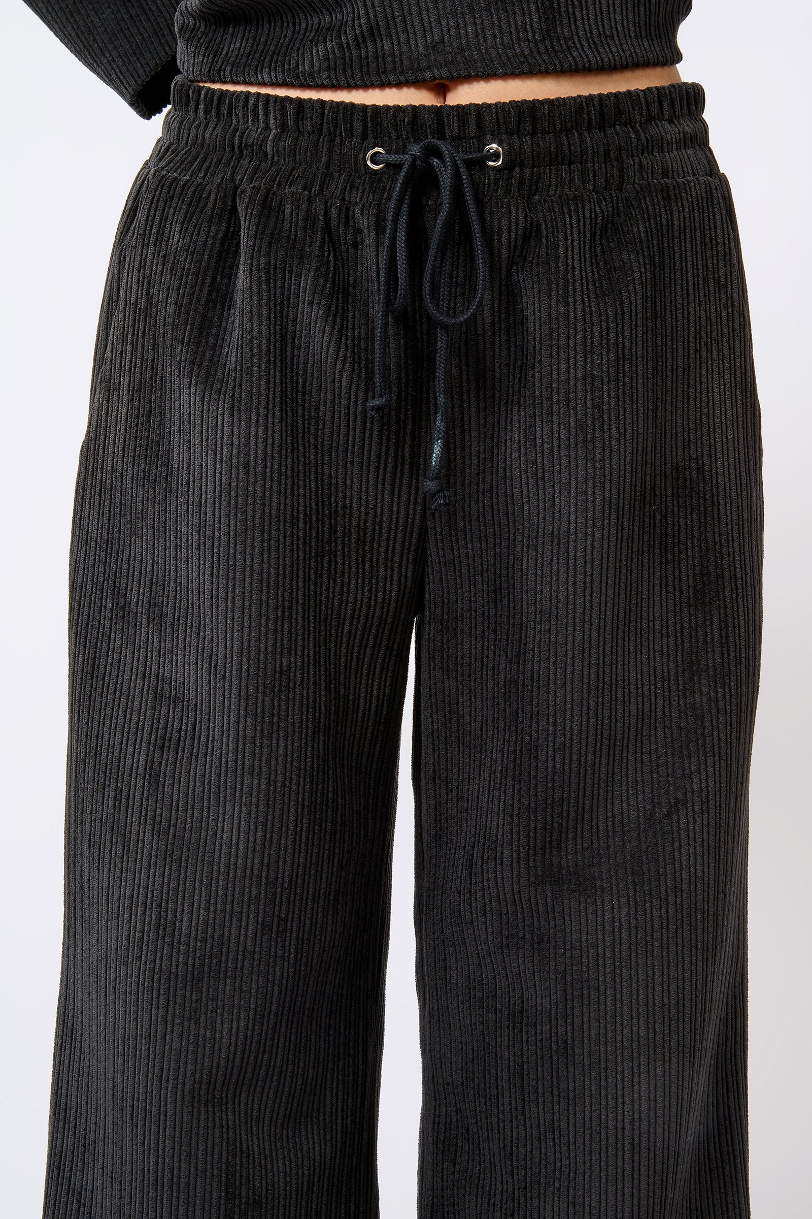 Kal Rieman Debbie Drawstring Pant in Black on Model Front Detail View of Drawstring Waistband