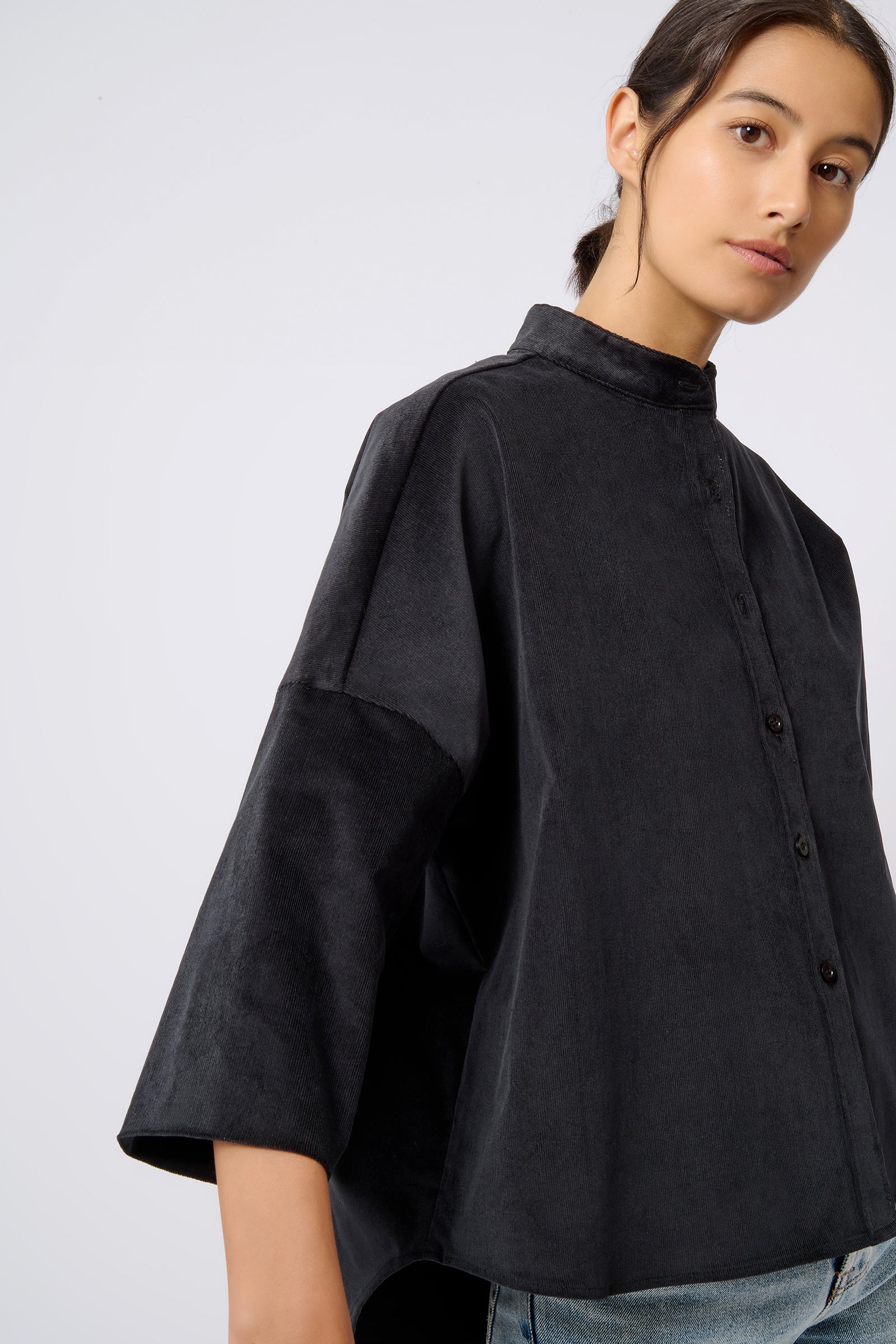 Kal Rieman Drop Shoulder Top in Black on Model Looking Right Front View