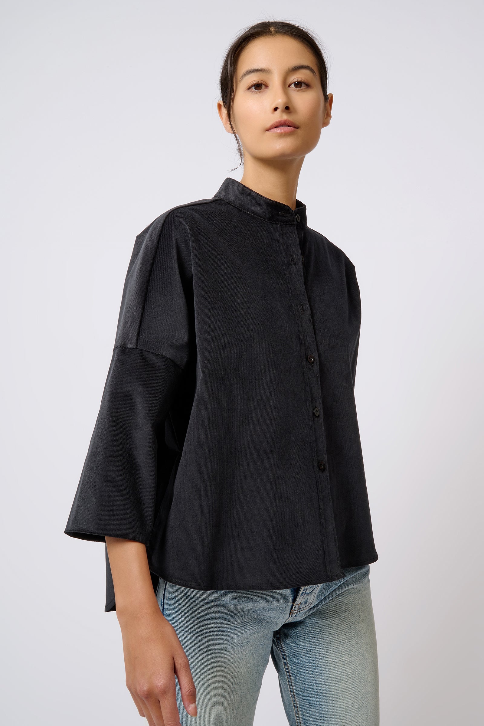 Kal Rieman Drop Shoulder Top in Black on Model with Head Tilted Front View