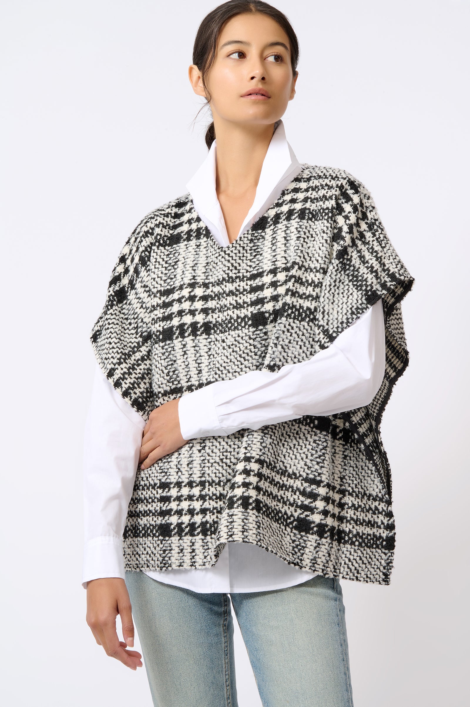 Kal Rieman Plaid Poncho in Black and White Plaid on Model with Arm Across Stomach Front View