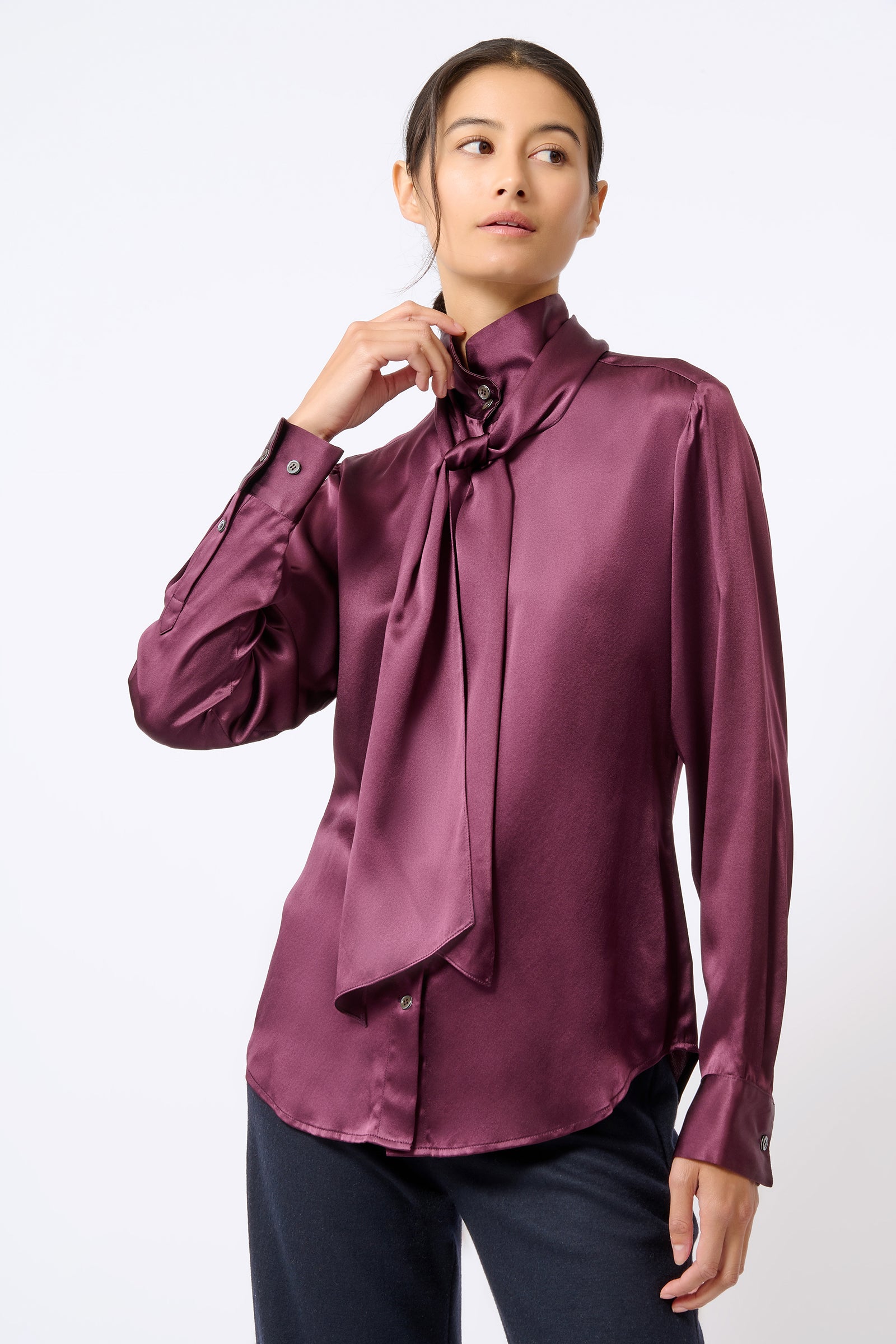 Kal Rieman Scarf Tie Blouse in Bordeaux on Model with Hand on Collar Front View
