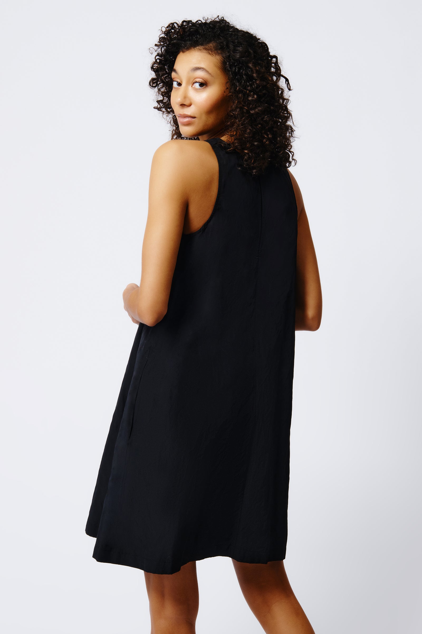 kal rieman trapeze dress in black on model back view crop