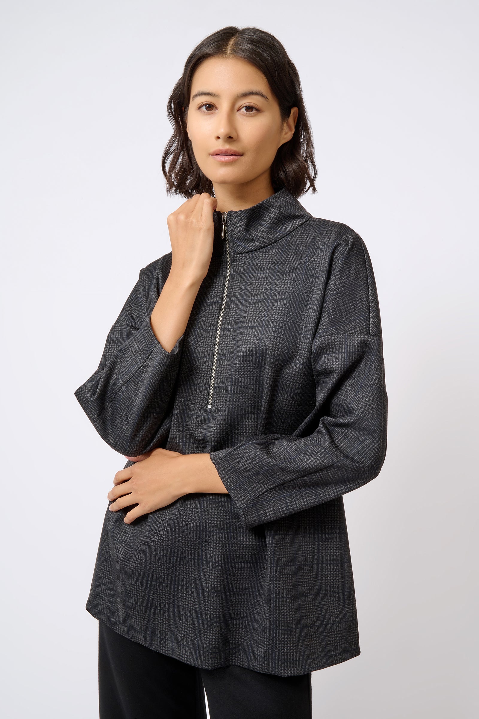 Kal Rieman Zip Mock Top in Black Plaid on Model with Hand Up Front View