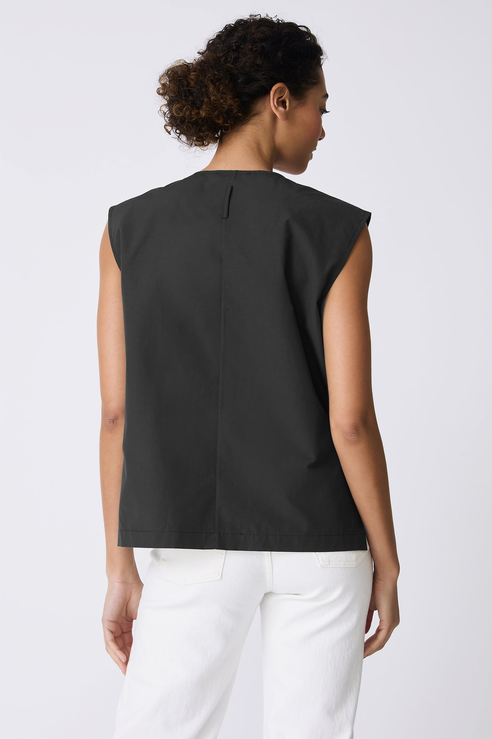 Kal Rieman Ava V-Neck Shell in Black on model touching neck front view