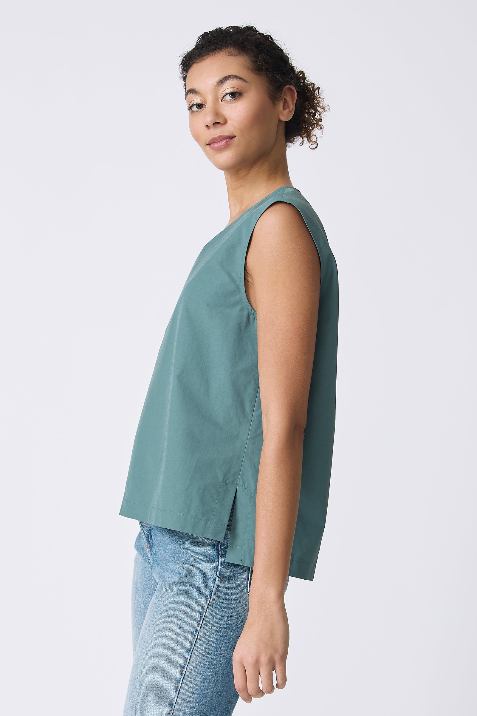 Ava V-Neck Shell Top in Sage on model looking at camera side view