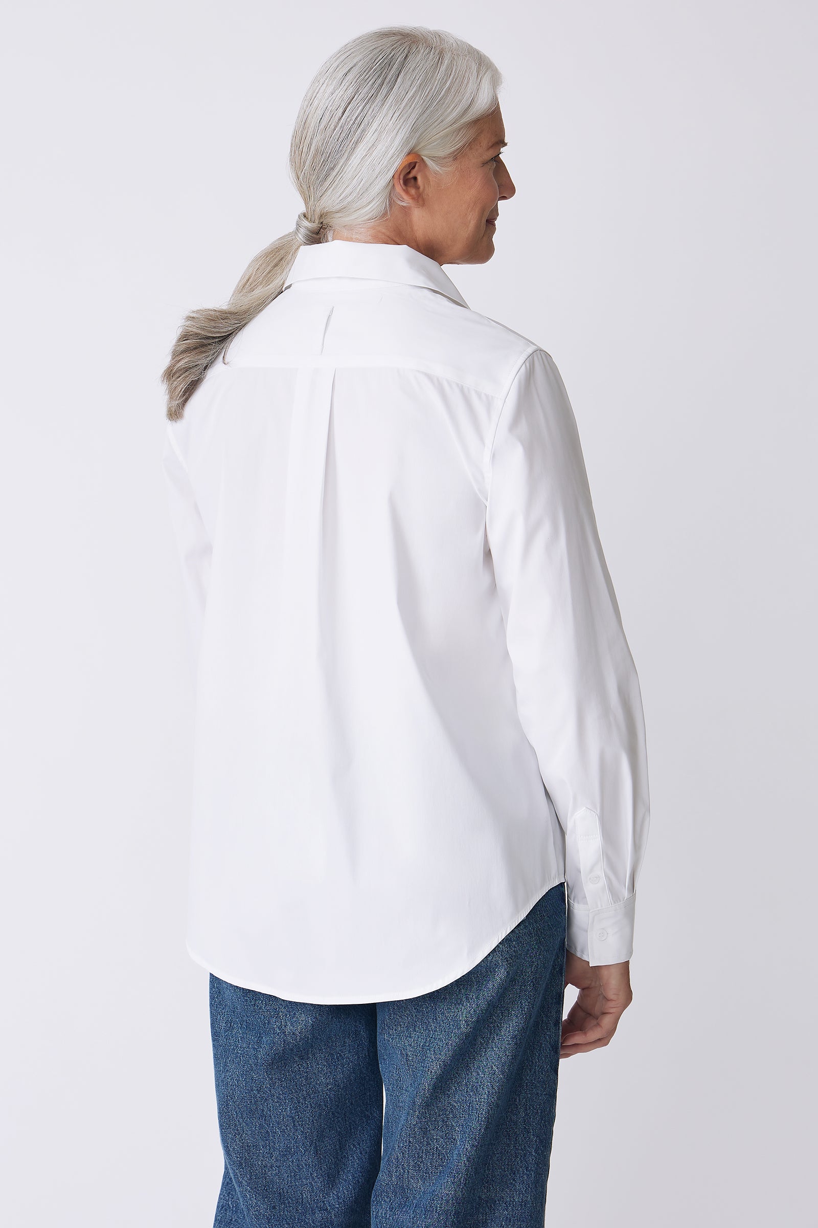 Kal Rieman Ginna Box Pleat Shirt in White Stretch on Model Front view hands touching