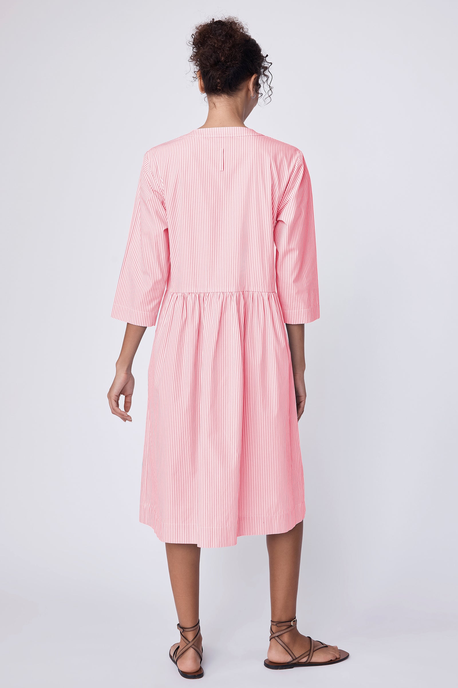 Kal Rieman Abby Shirred Shirt Dress in peach stripe on model with hands in pockets full front view