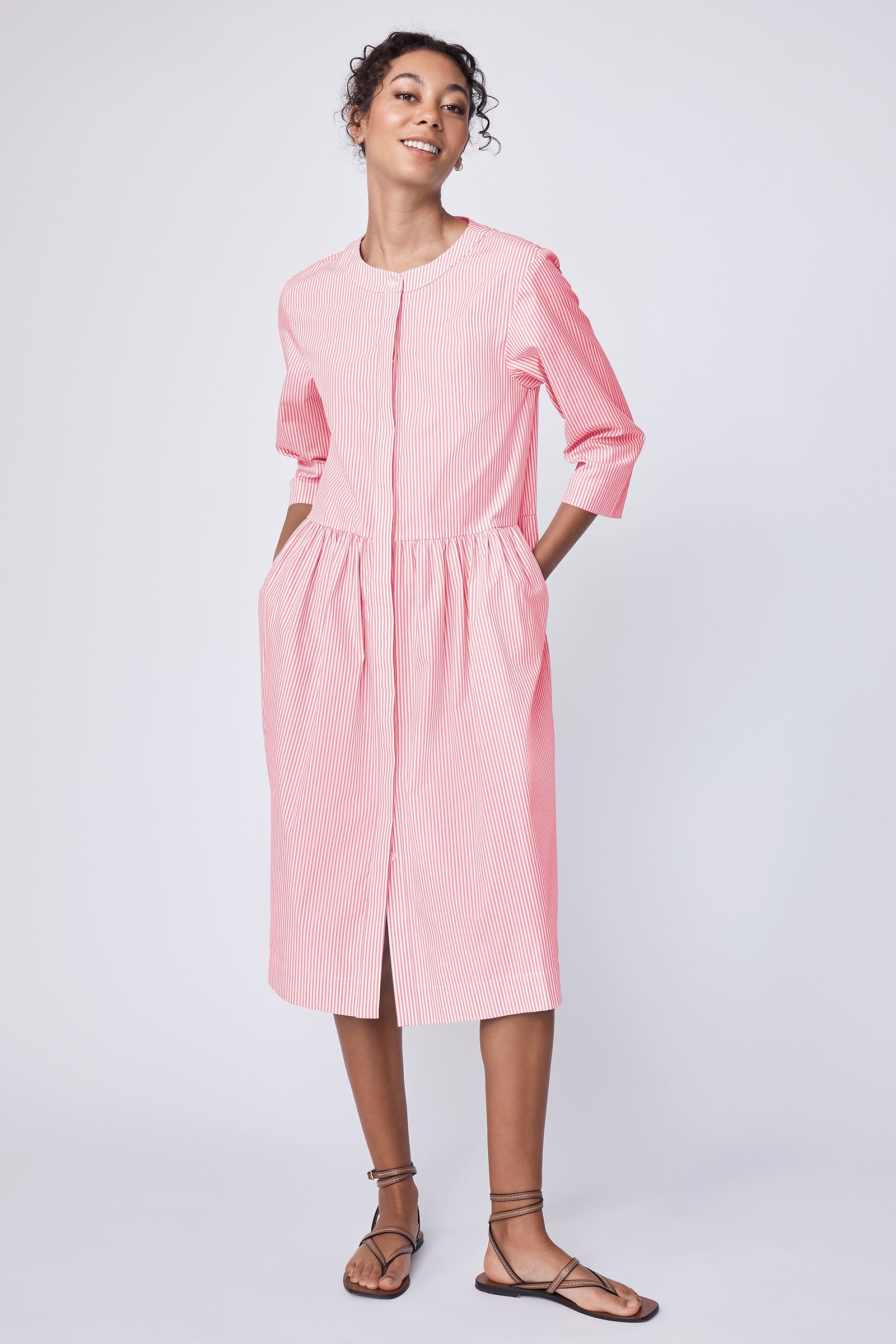 Kal Rieman Abby Shirred Shirt Dress in peach stripe on model with hands in pockets full front view