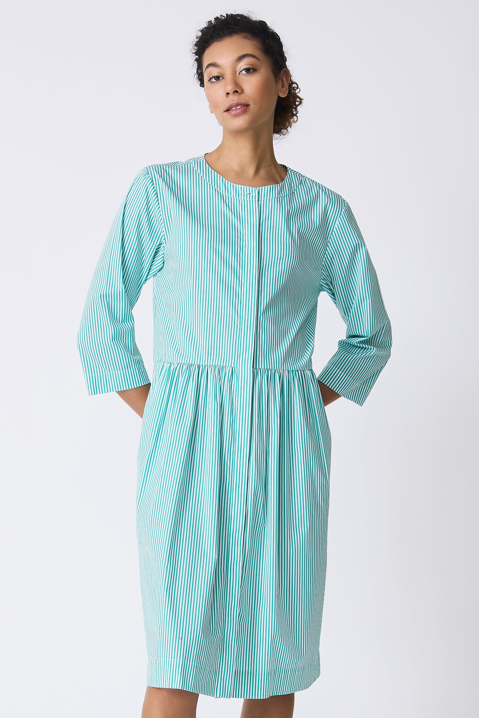 Kal Rieman Abby Shirt Dress in Miami Stripe Green on model with hands behind back front view
