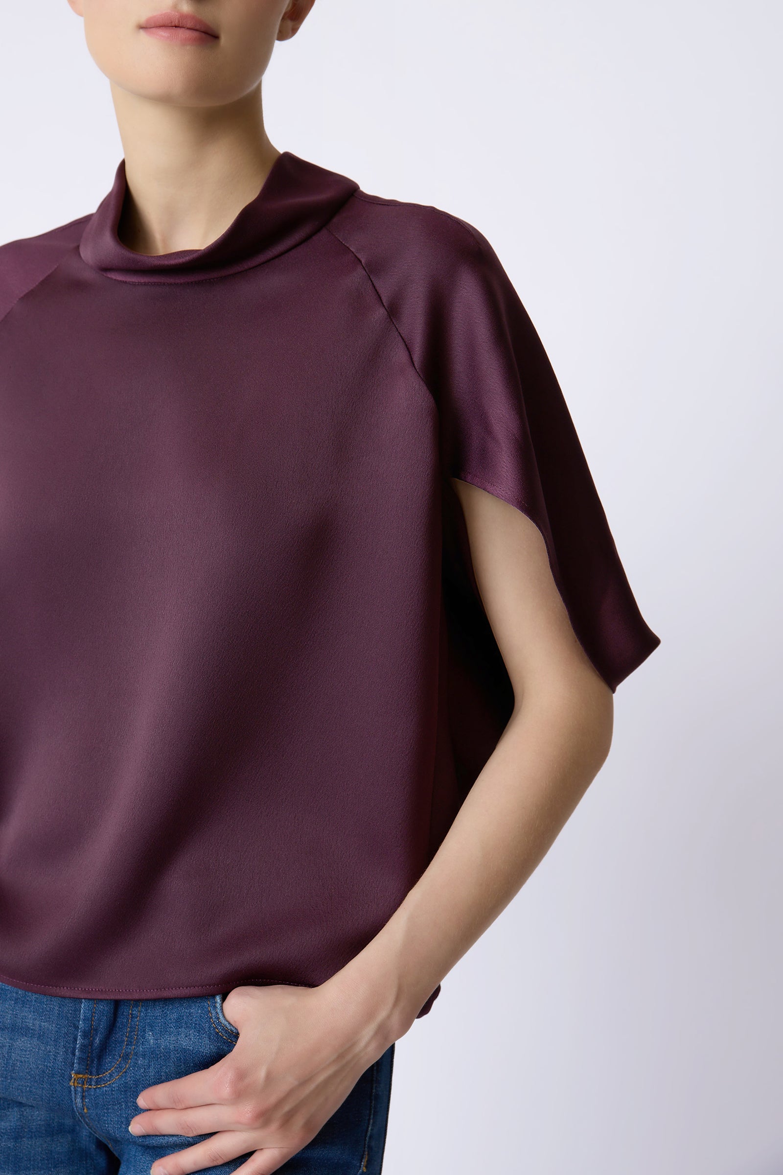 Kal Rieman Angelica Cape Top in Bordeaux on model with right hand in pocket front view