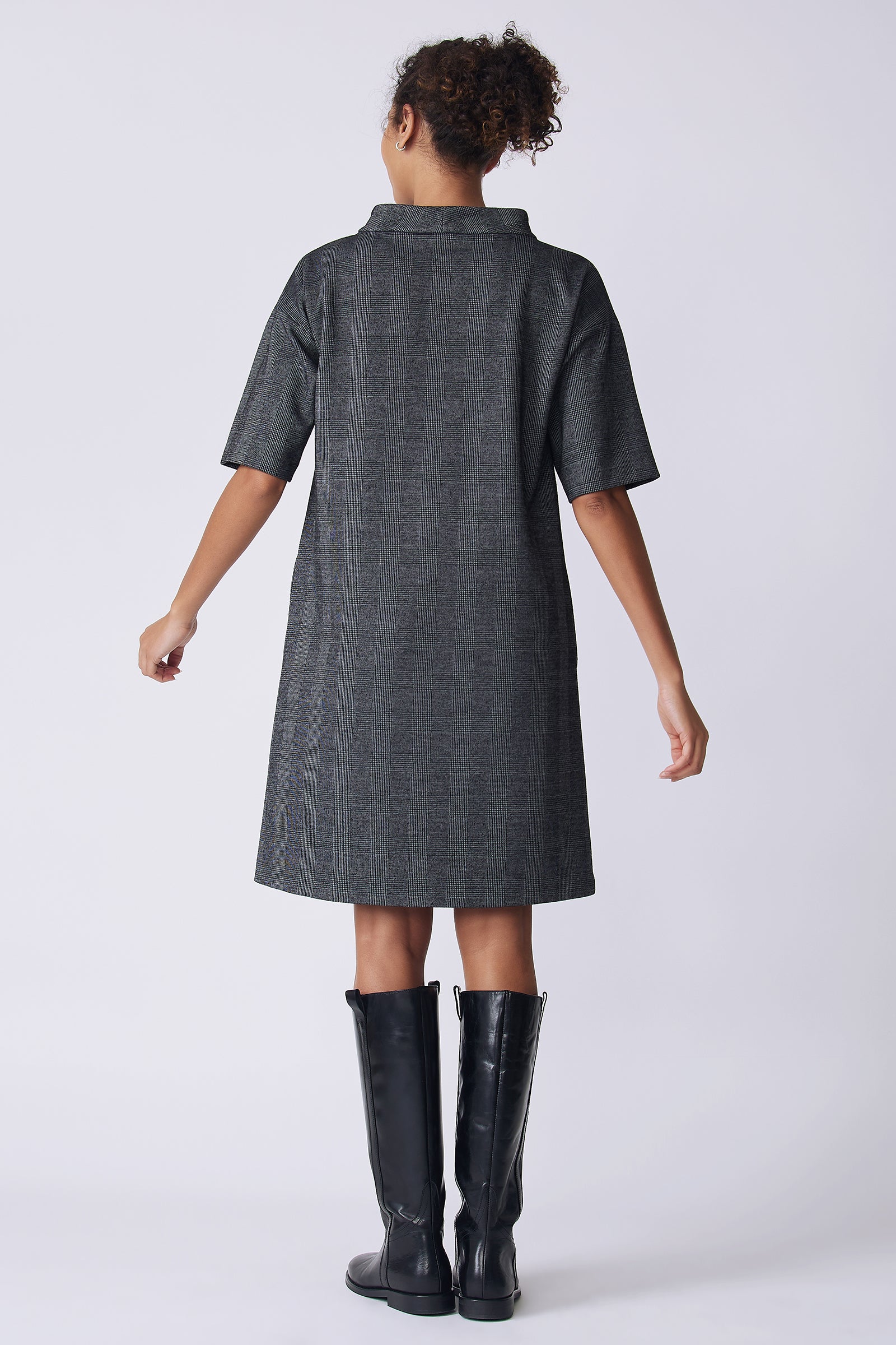 Kal Rieman Avery Dress in black plaid on model front view hands in pockets