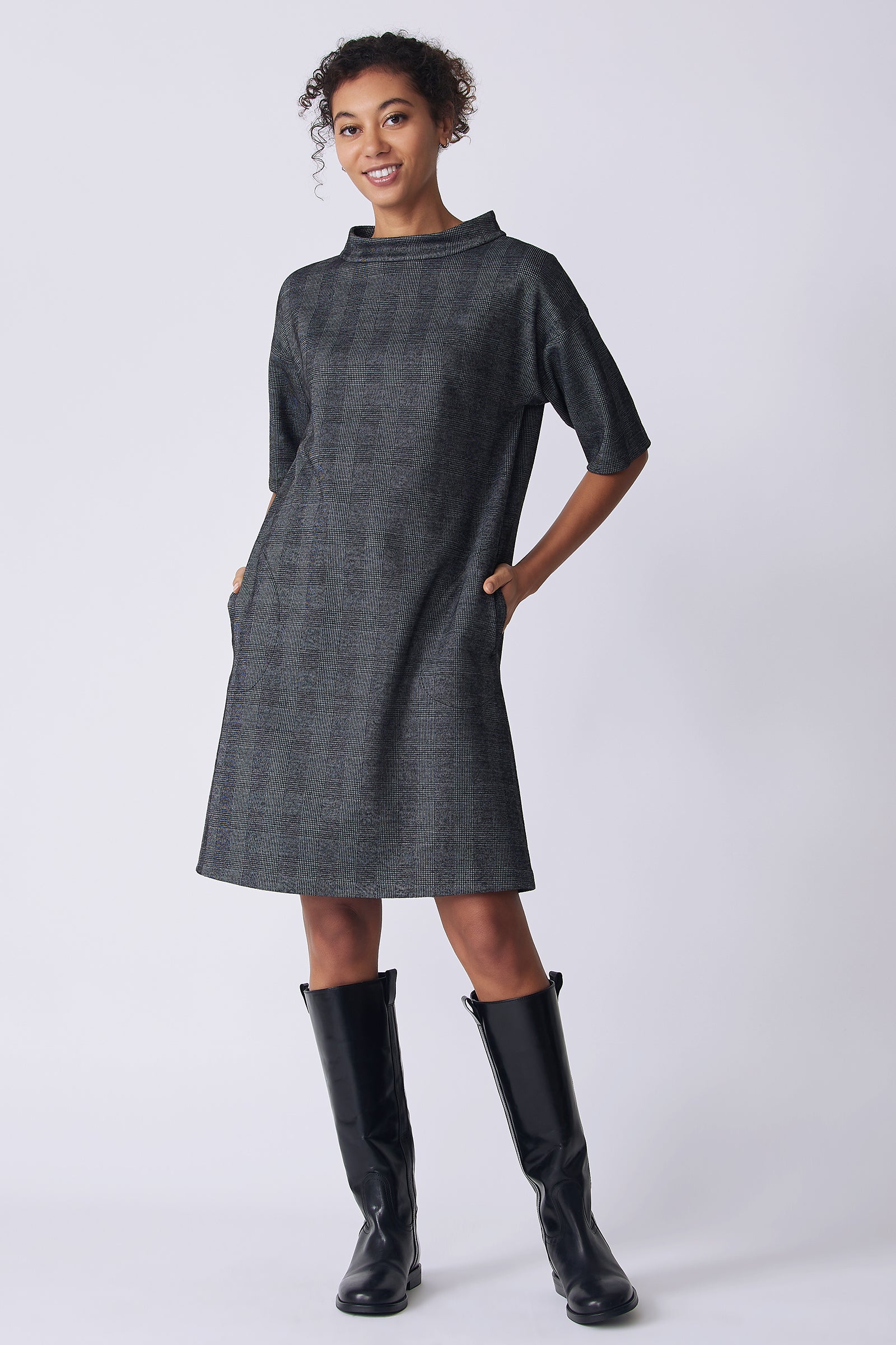 Kal Rieman Avery Dress in black plaid on model front view hands in pockets