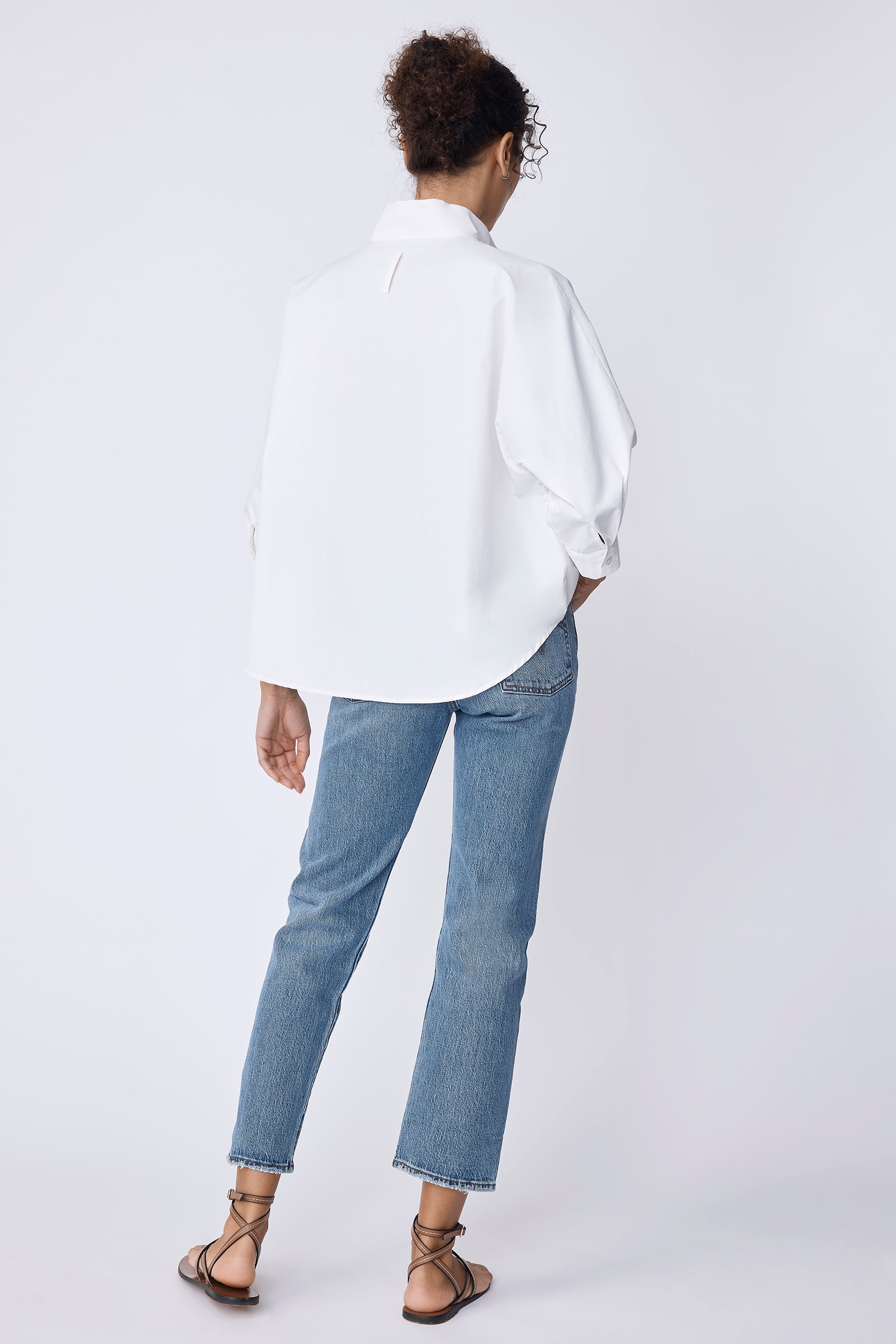 Kal Rieman Avi Shirt in Ecru on model with hands by hips front view