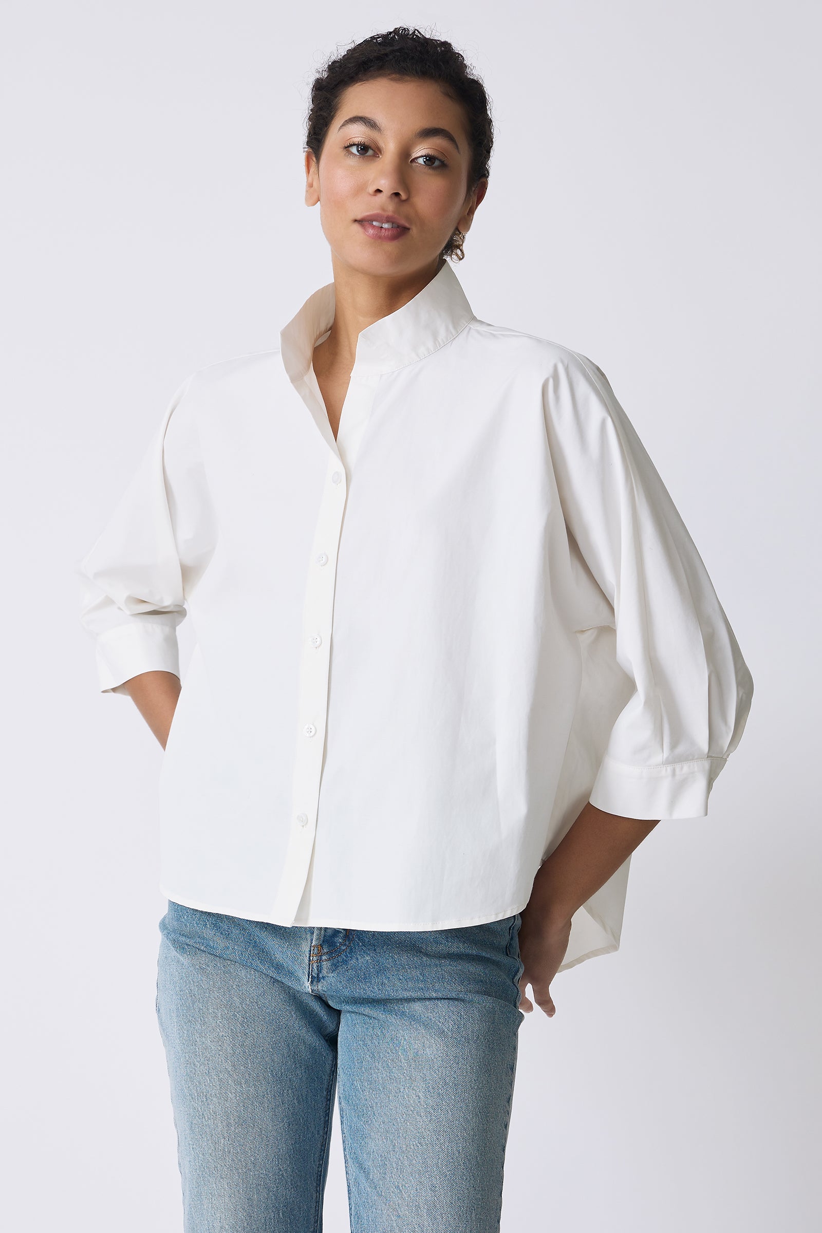Kal Rieman Avi Shirt in Ecru on model with hands by hips front view