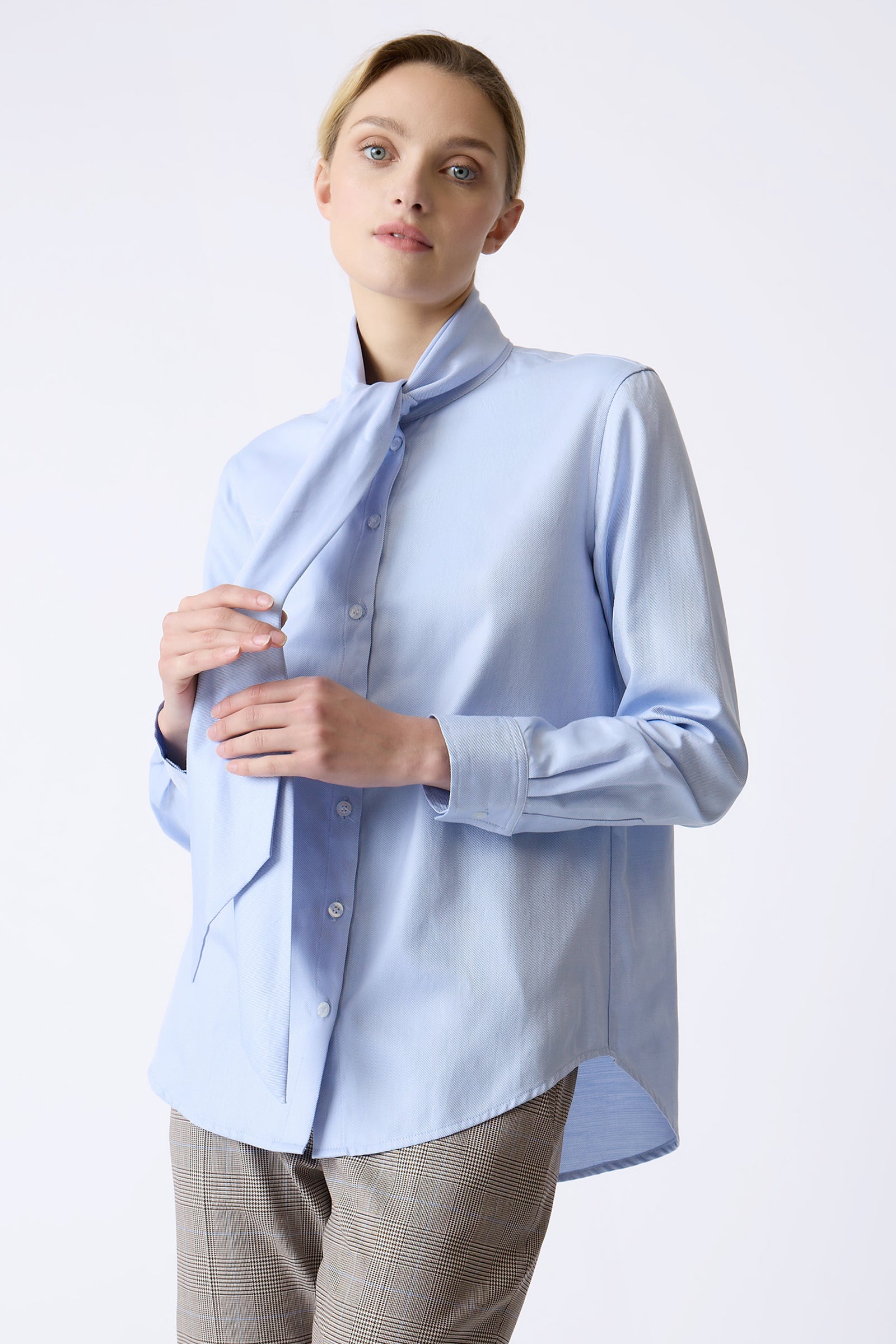 Kal Rieman Bella Tie Blouse in Blue Soft Twill on model touching tie front view