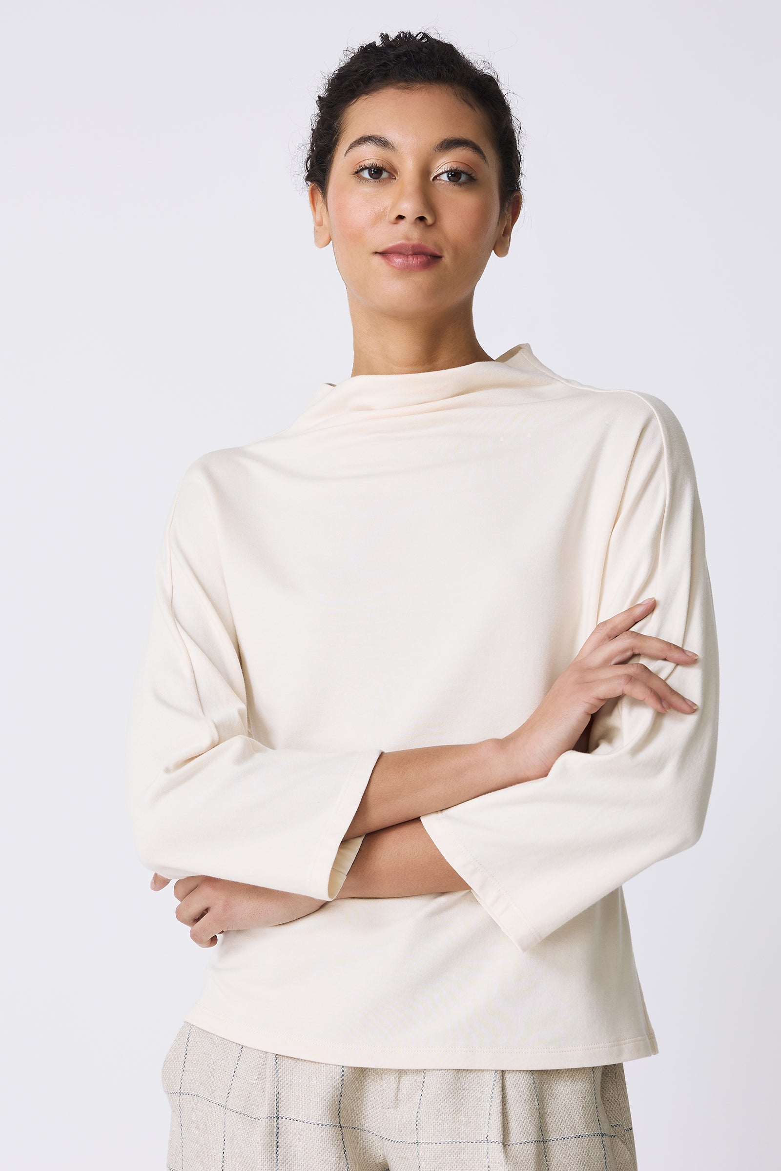 Kal Rieman Brigitte Mock Funnel Top in Ivory on model with arms crossed front view