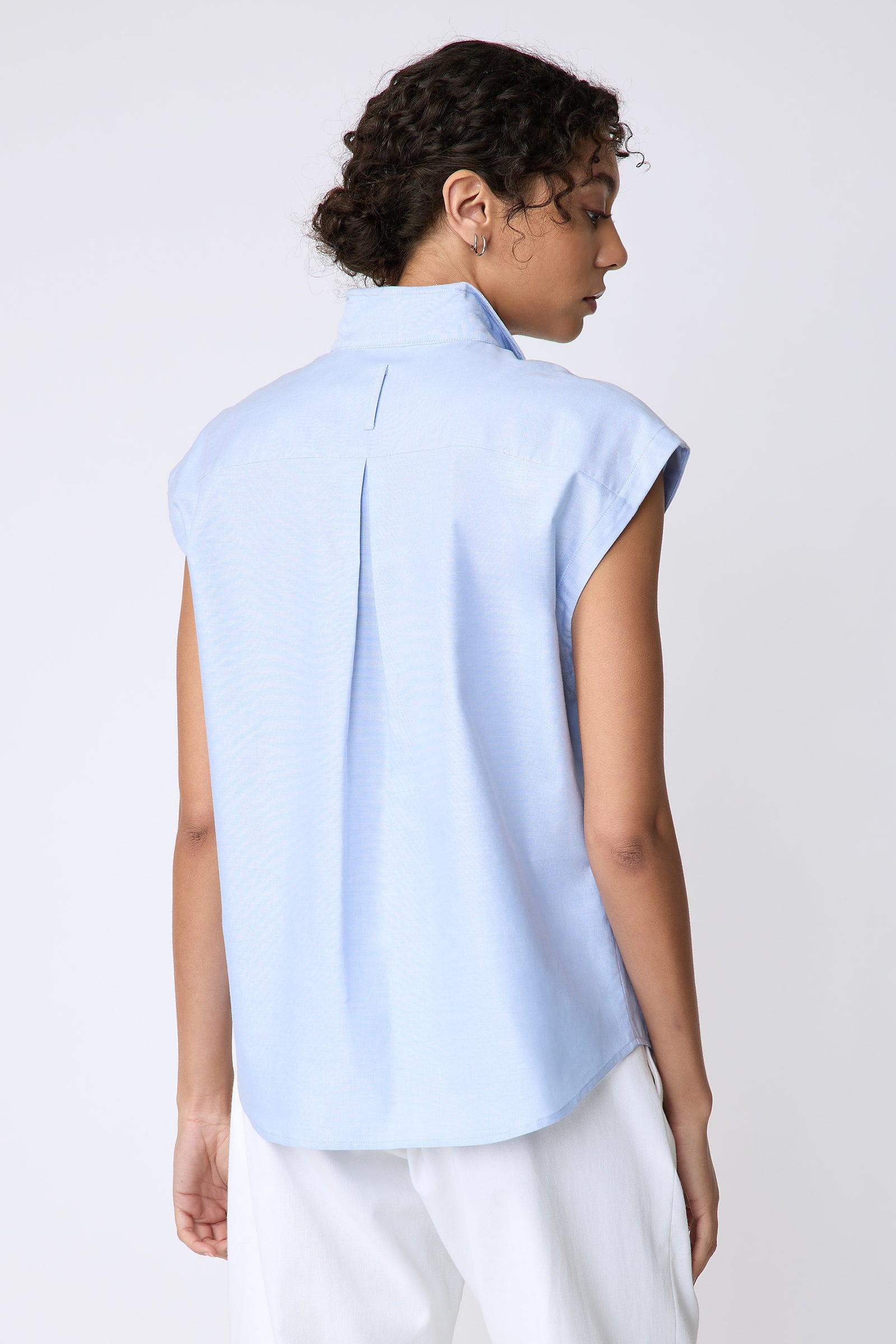 Kal Rieman Candice Cap Sleeve Double Collar Shirt in oxford blue on model front view holding front of shirt