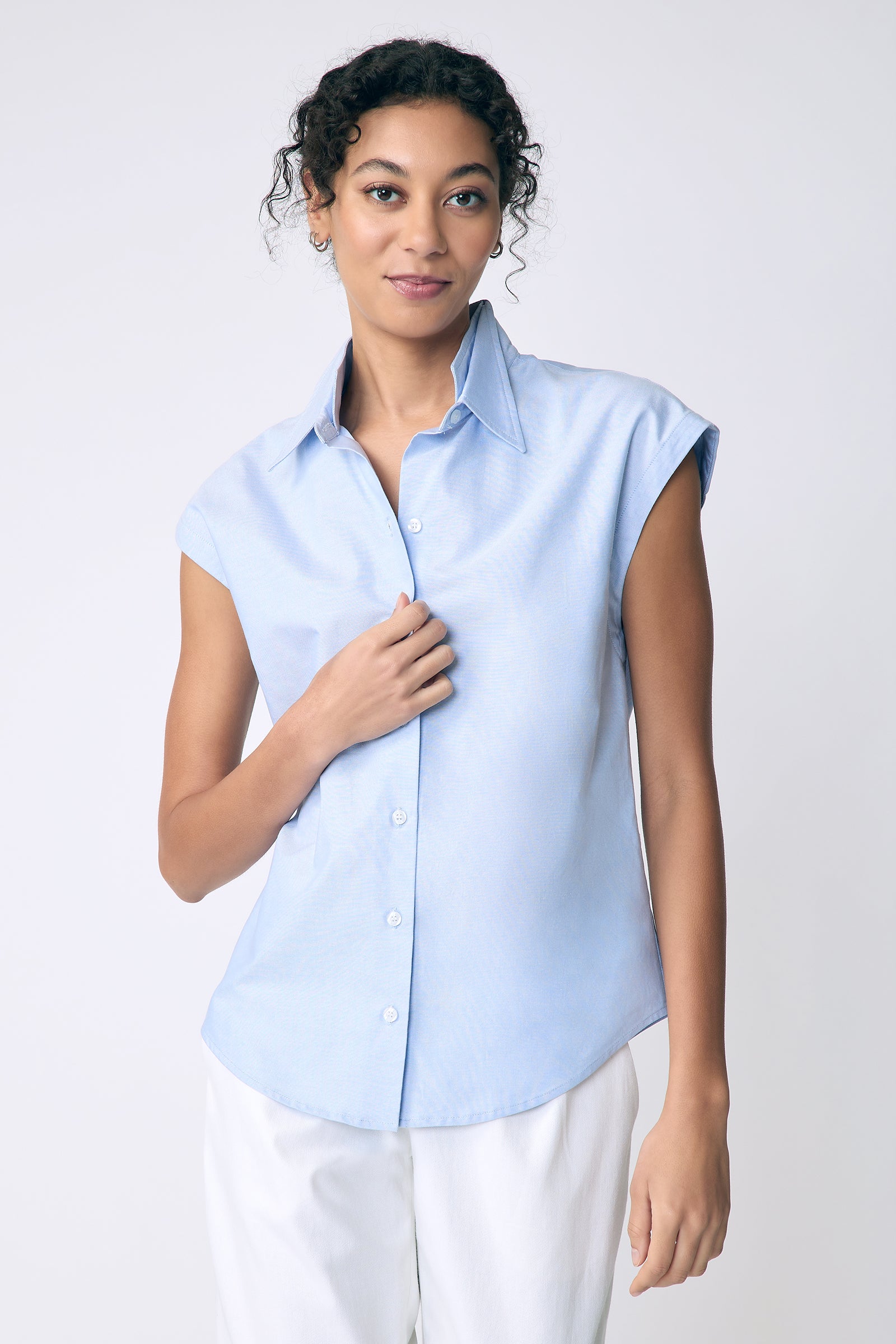 Kal Rieman Candice Cap Sleeve Double Collar Shirt in oxford blue on model front view holding front of shirt