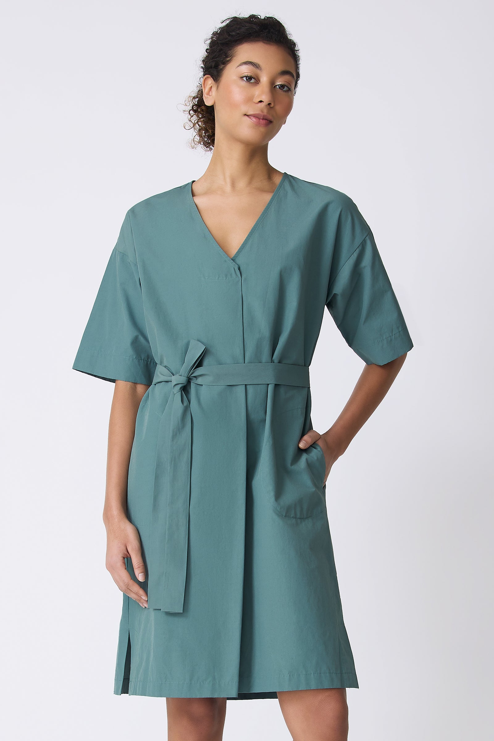Kal Rieman Cara Fold Front Dress in Sage on model with hand in pocket front view