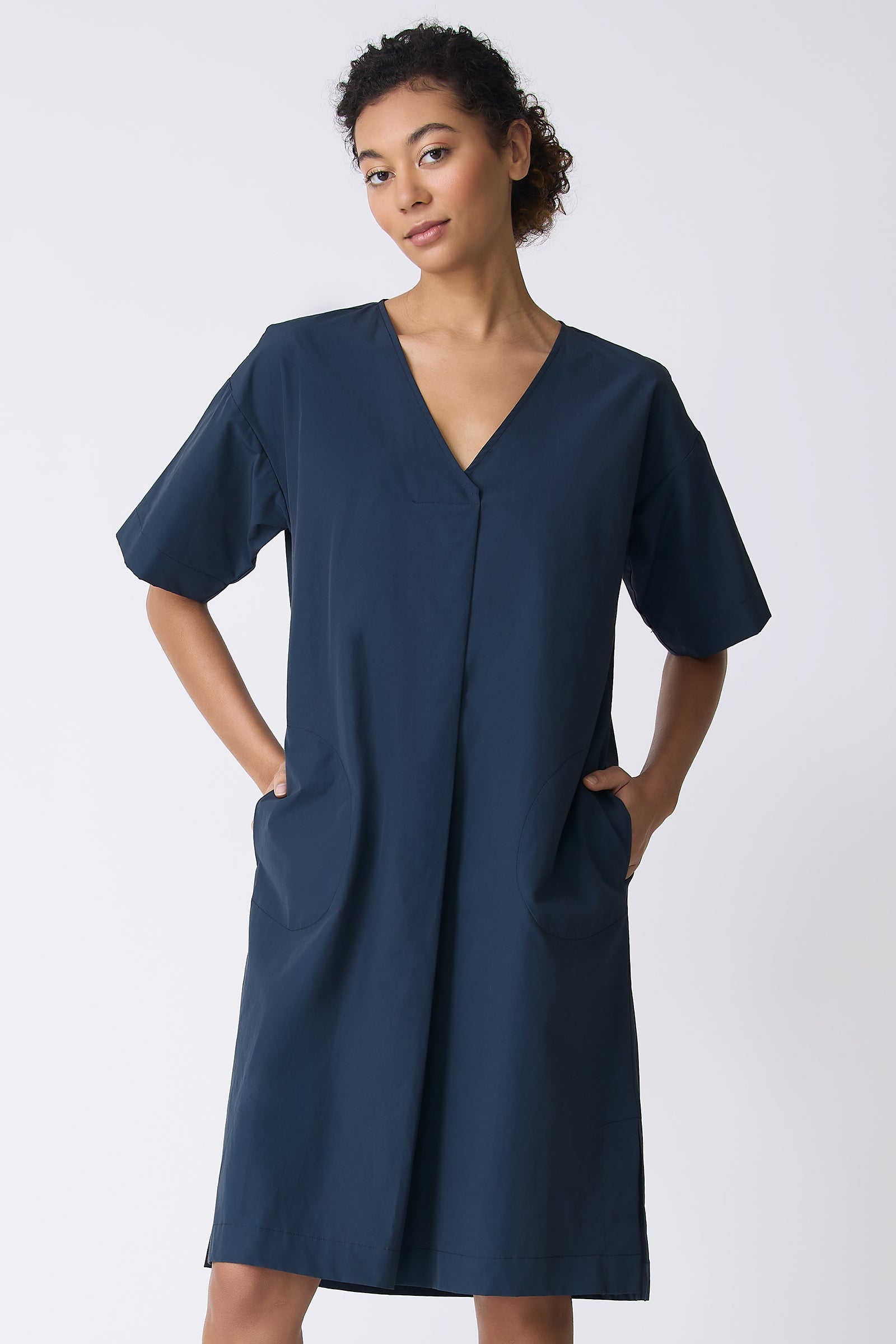 Kal Rieman Cara Fold Front Dress in Summer Navy on model with hands in pockets front view