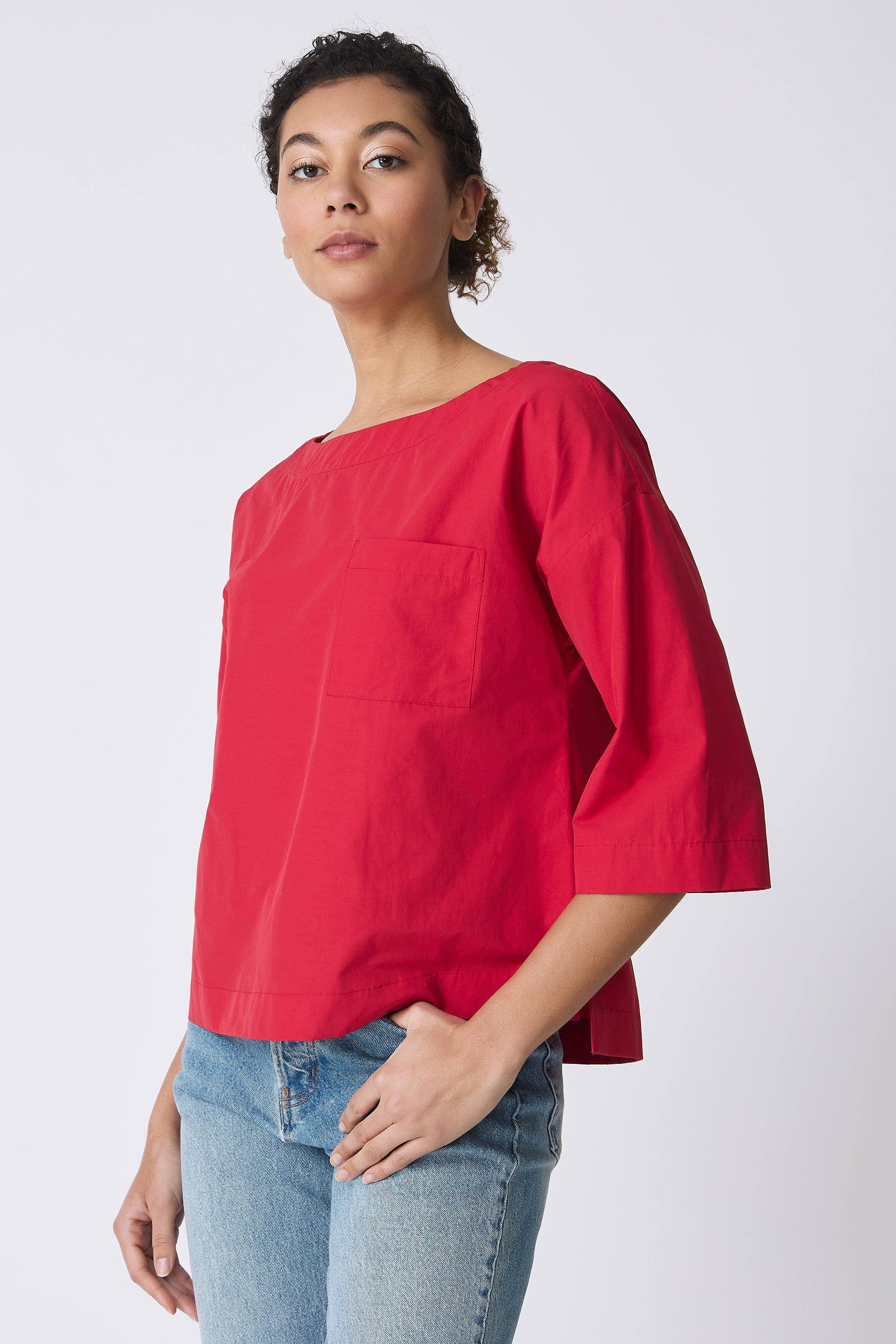 Kal Rieman Carmen Pocket Tee in Red on model with hand in pocket front view