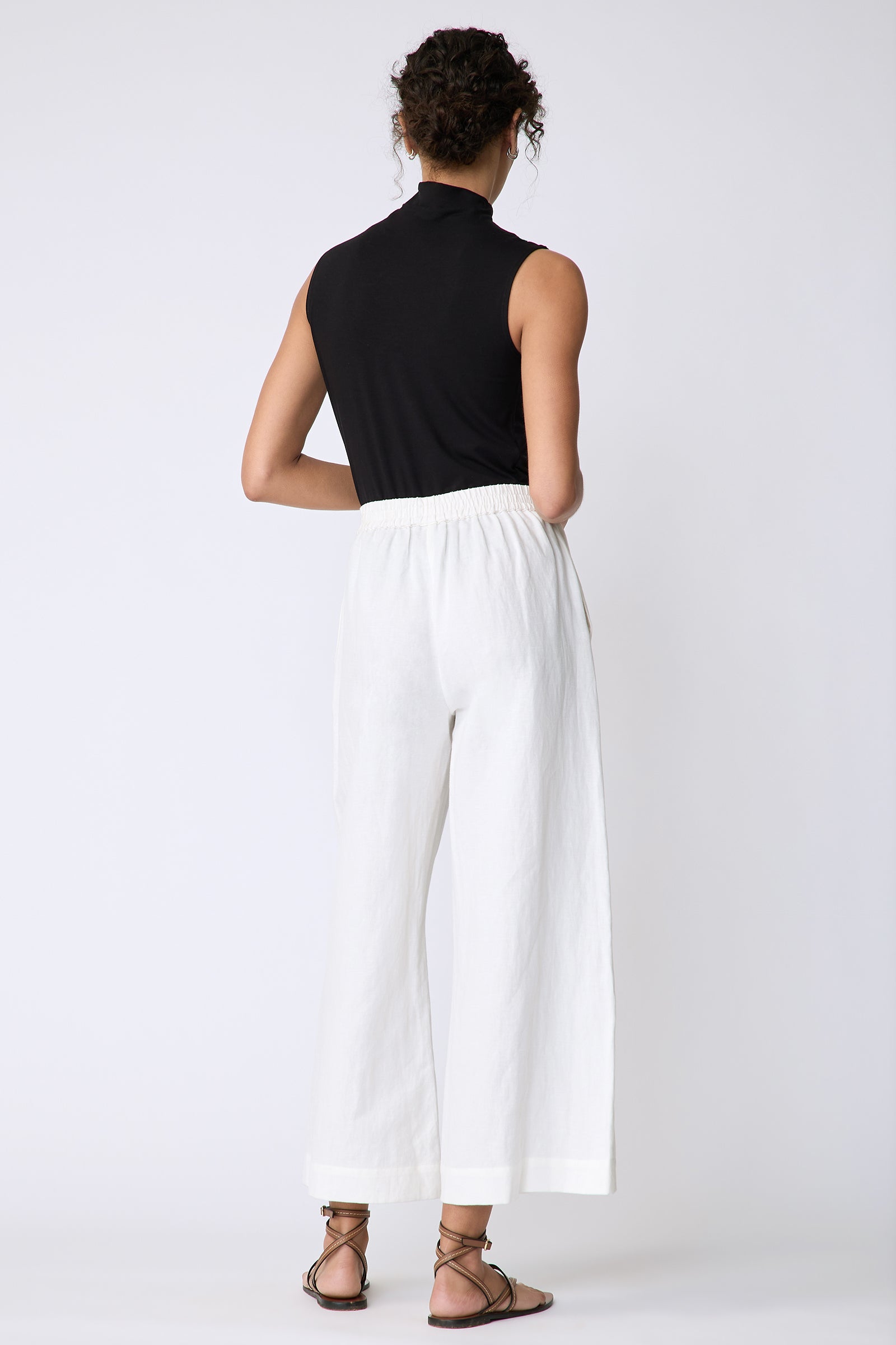 Kal Rieman Celeste Pant in Ecru Cotton linen on model front view hands in pockets