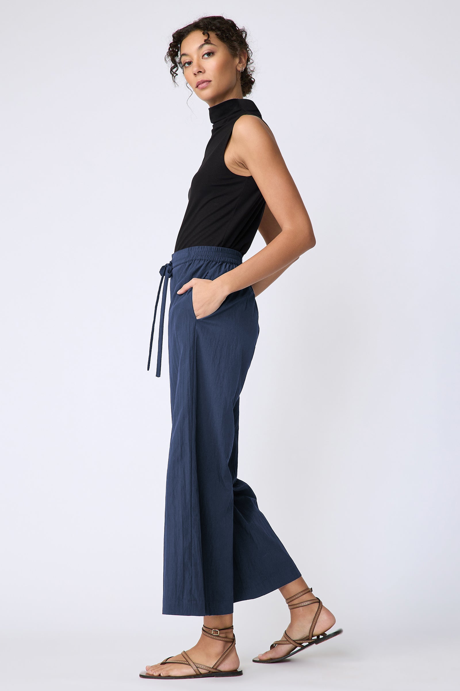 Kal Rieman Celeste Pant in navy typewriter cloth on model side view walking