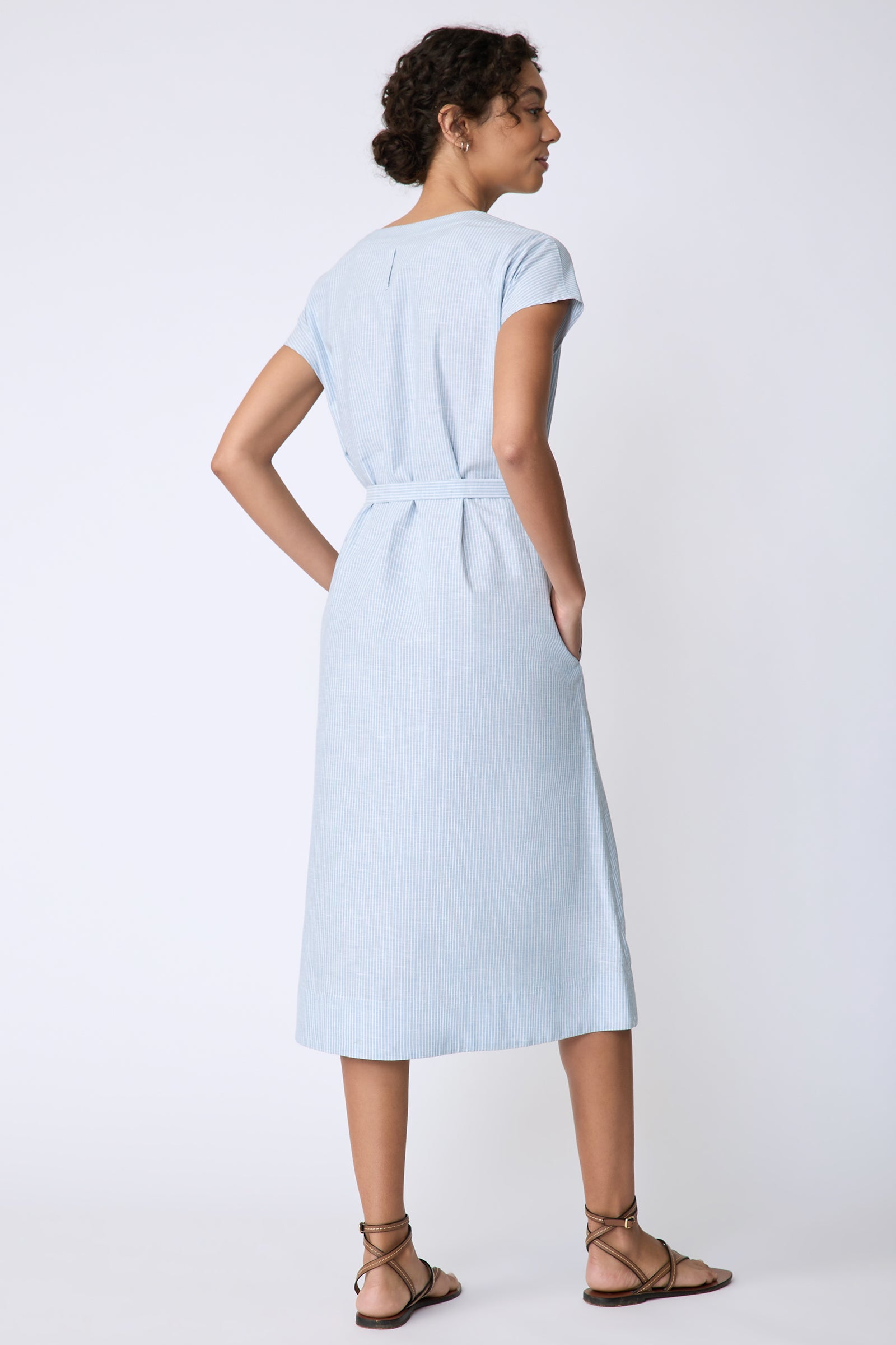 Kal Rieman Clara Dress in light blue mini stripe on model front view hands behind back