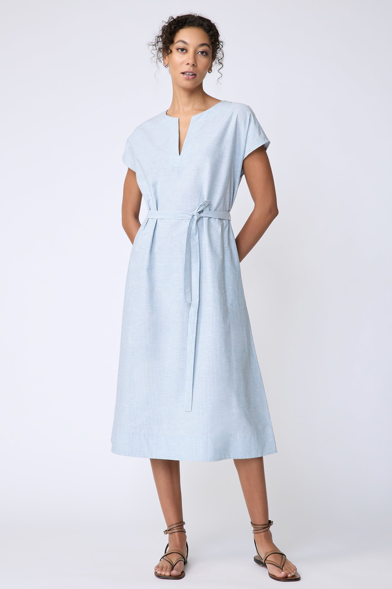 Kal Rieman Clara Dress in light blue mini stripe on model front view hands behind back