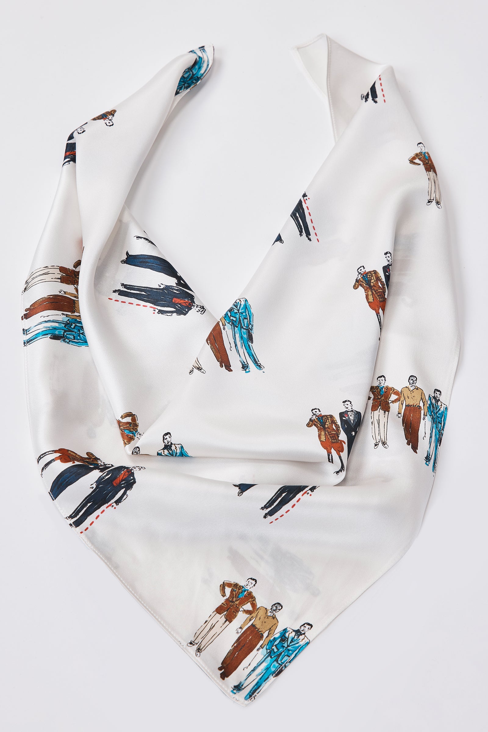 Woman wearing a black sleeveless top with a dandy print scarf around her neck against a white background