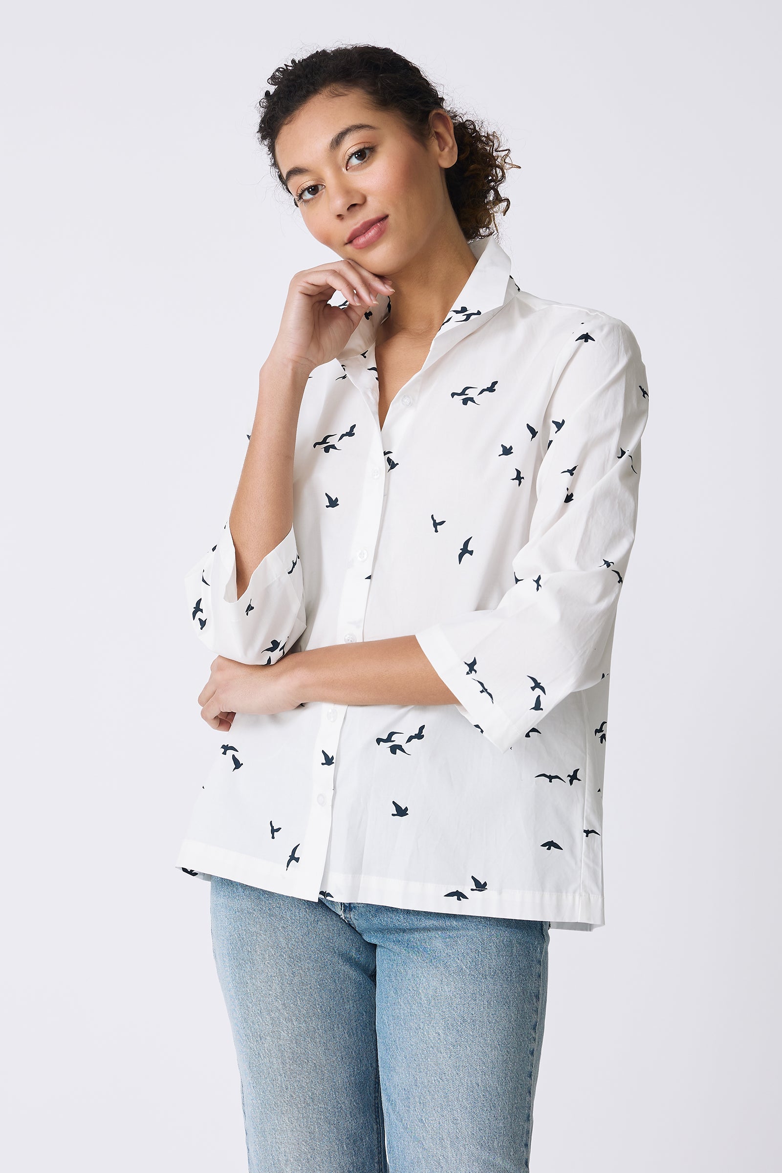 Kal Rieman 3/4 Sleeve Ginna Shirt in White Bird Print on model with hand under chin front view