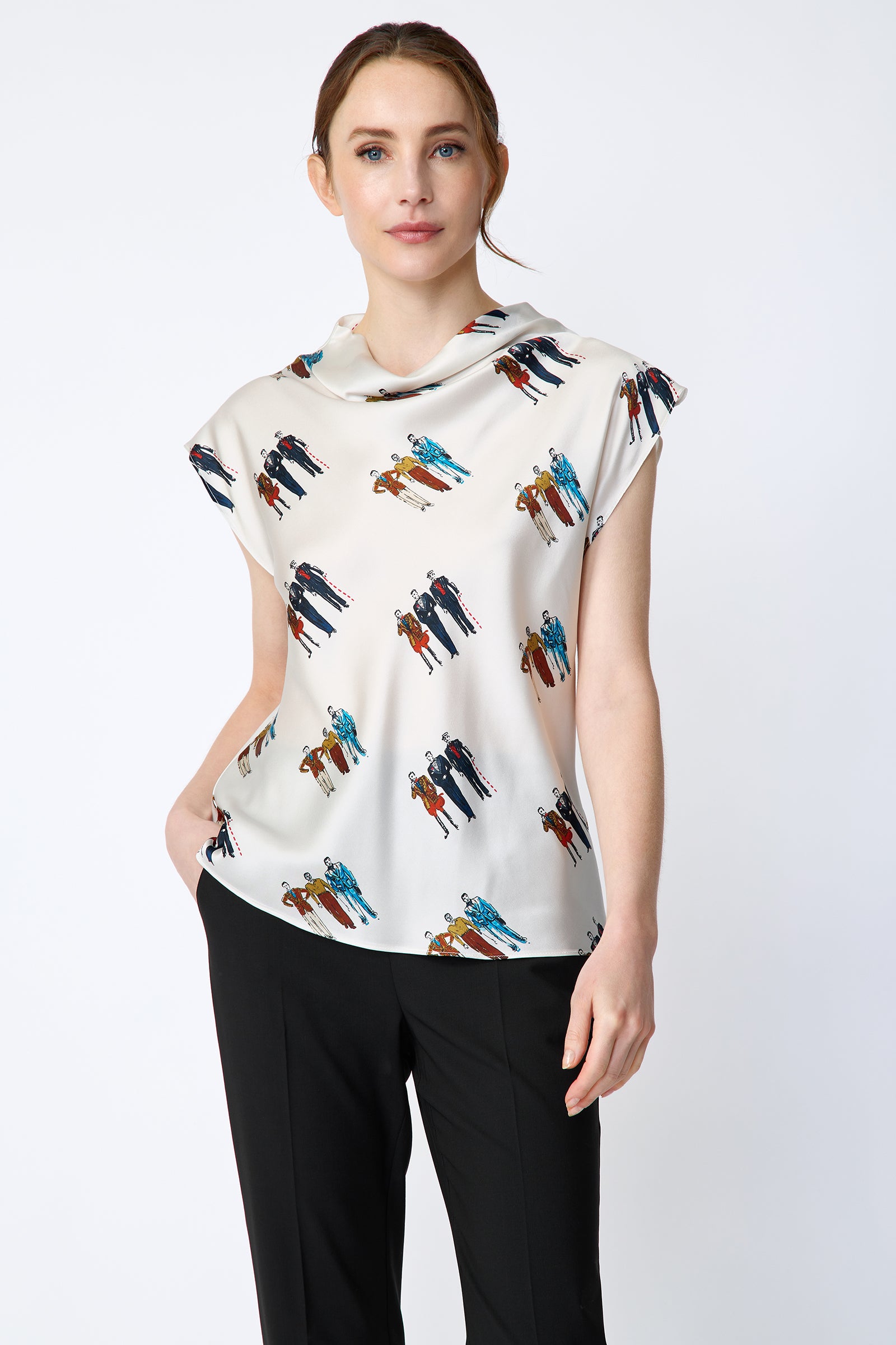 Woman wearing Kal Rieman Gloria Drape Top in Dandy Print and black pants on a white background hand in pocket arm on side, close view