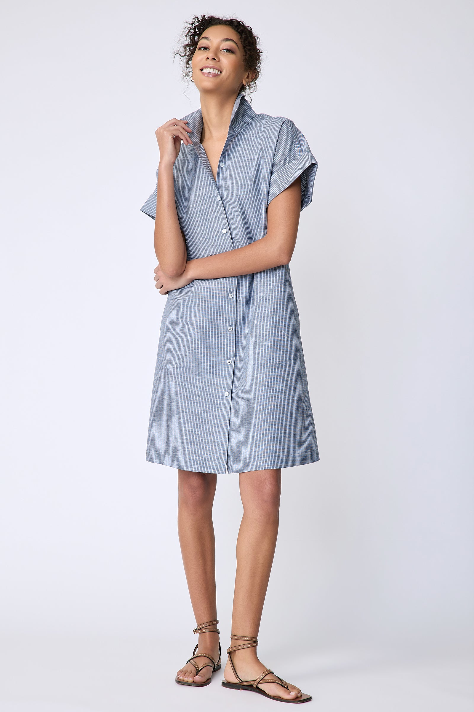 Kal Rieman Holly Kimono Dress in dark indigo mini stripe on model front view holding collar