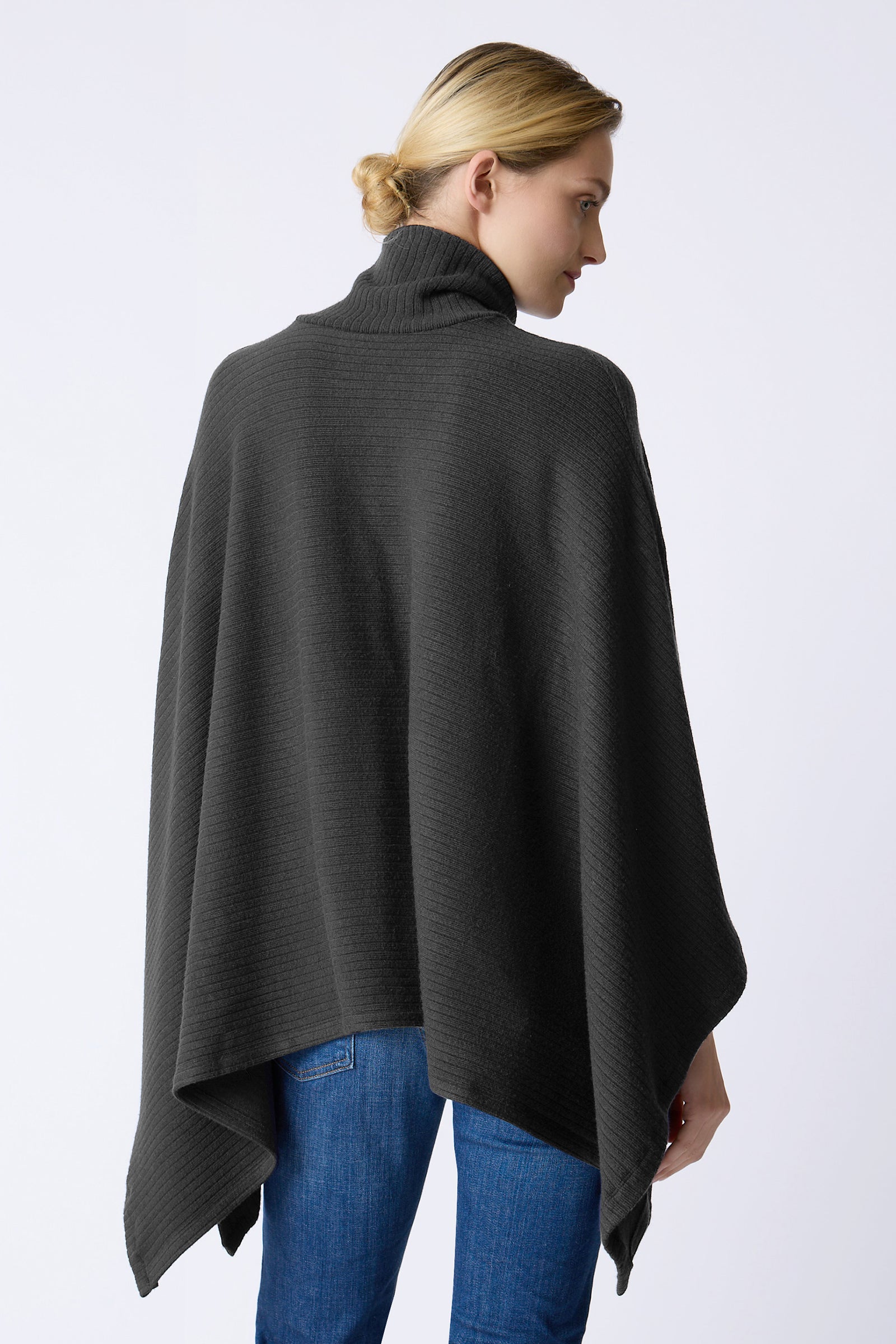 Kal Rieman Lee Rib Poncho in black on model swinging arms full front view