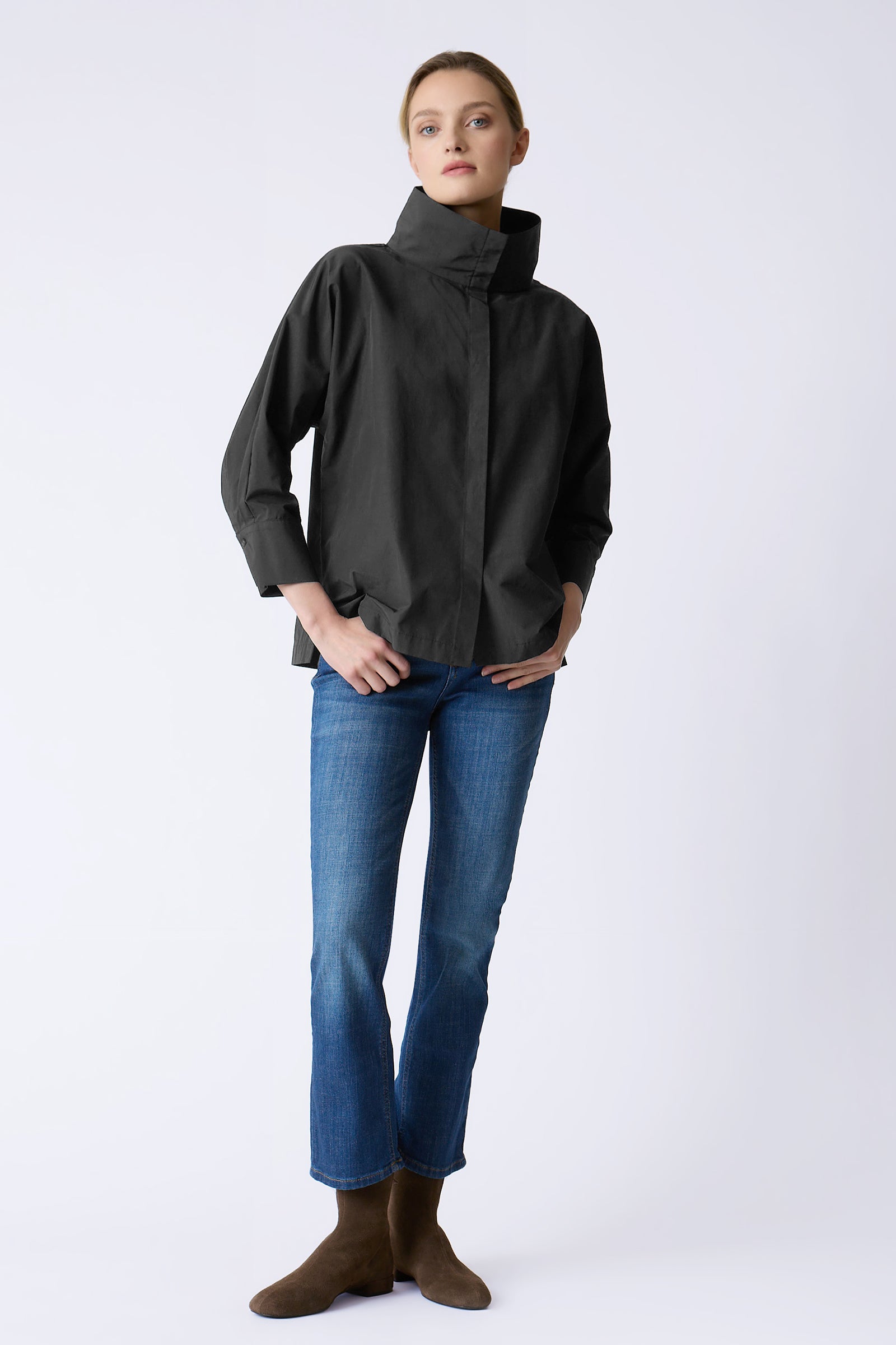 Kal Rieman Loren Top in Black on model with thumbs in pockets full front view